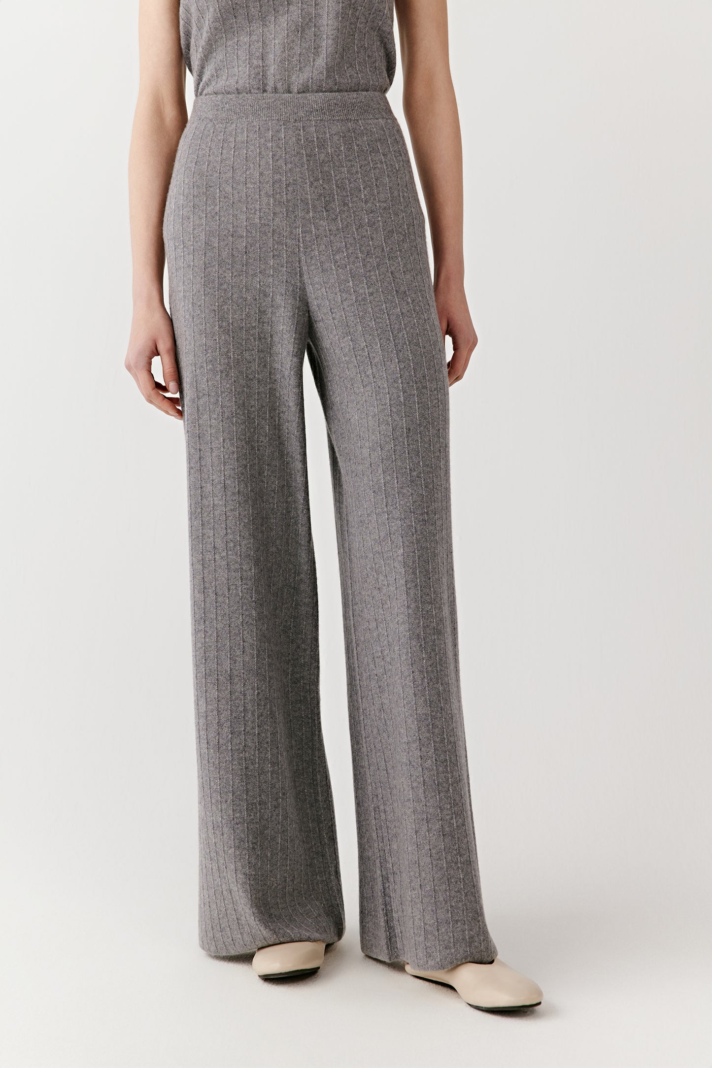 Back view of the gray sleeveless knit outfit, showing the straight cut of the pants and fitted shape of the top.