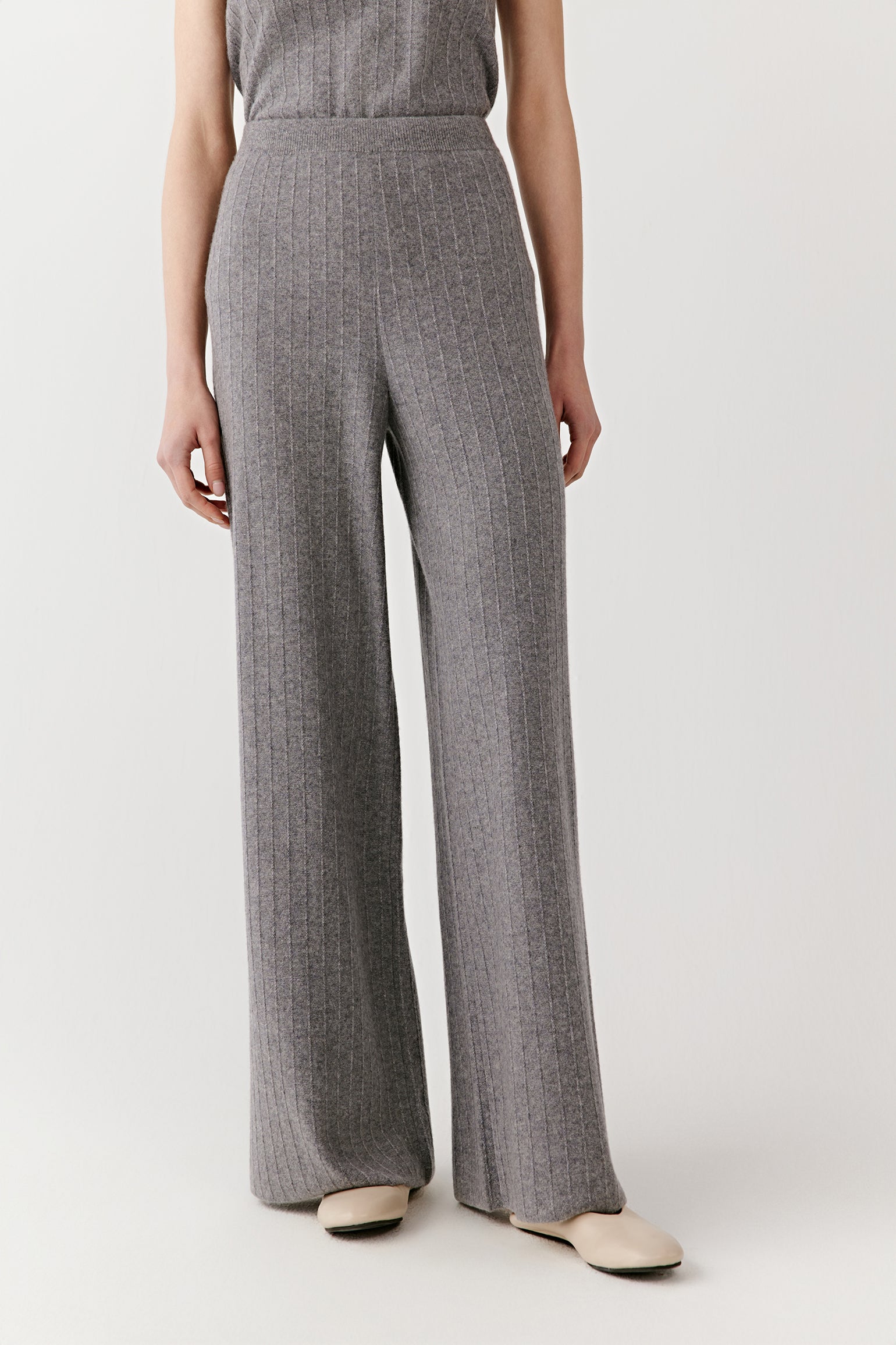 Back view of the gray sleeveless knit outfit, showing the straight cut of the pants and fitted shape of the top.