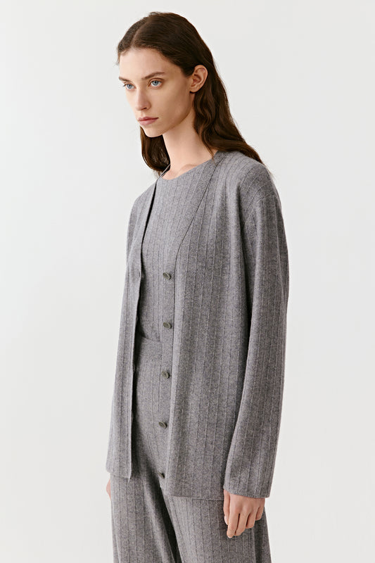 Side view of the gray knit cardigan and pants, showing soft drape and relaxed silhouette.