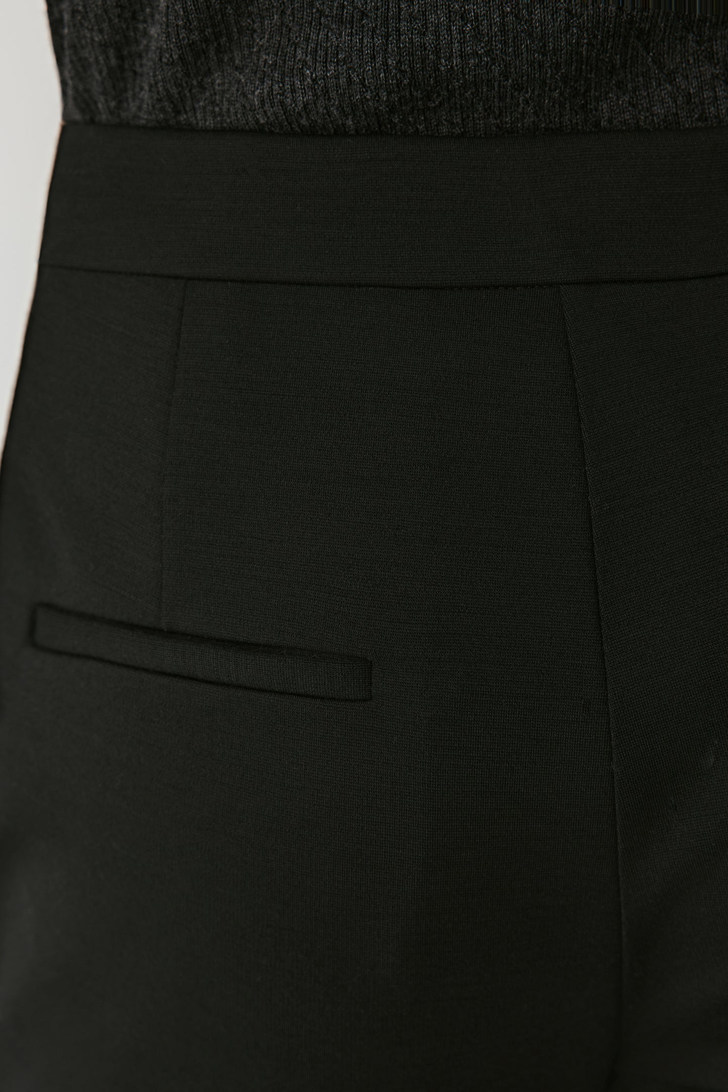 Close-up of the back waist detail showing the fine stitching and smooth wool finish.