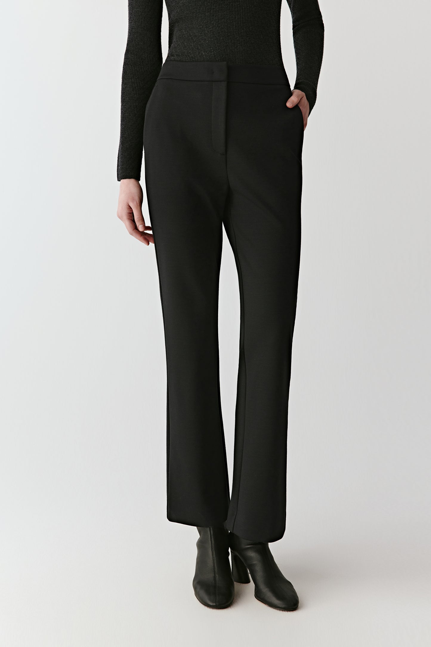 Front view emphasizing the smooth drape and clean pressed lines of the trousers.