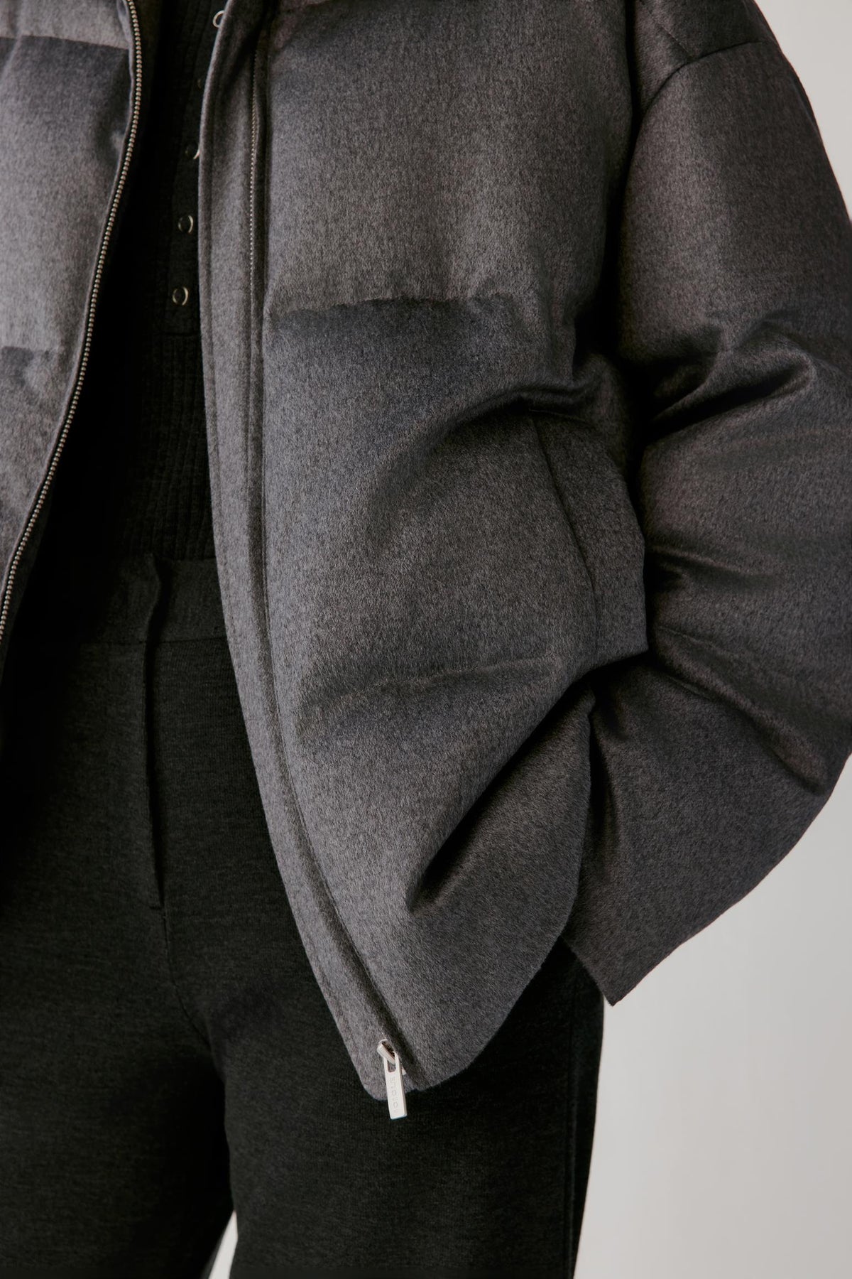 Close-up highlighting the patch pocket, horizontal quilting and dark grey melange silk tweed texture.