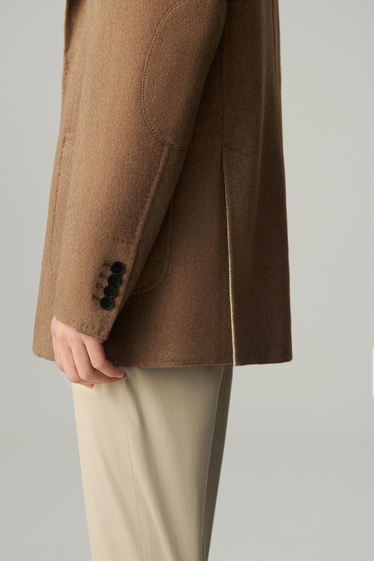 Close-up of the sleeve and hem, showing the clean finish of the brown cashmere and wool blazer.
