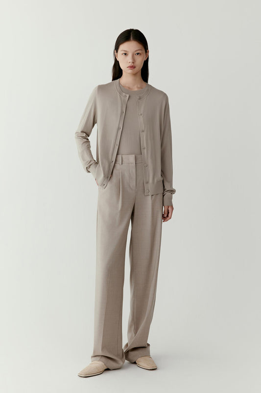 Full-length front view showing the cardigan paired with matching taupe trousers. The cardigan falls naturally over the torso with a relaxed fit and straight hemline.