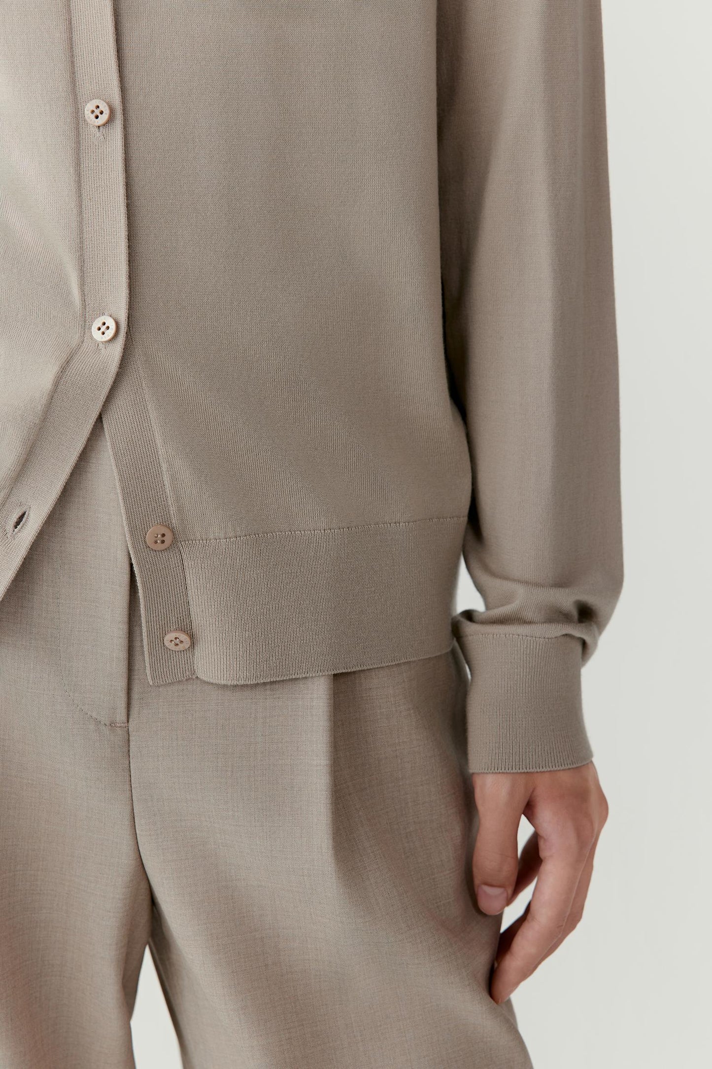 Another close-up highlights the sleeve and cuff detail, showing the neat ribbed edges and even stitches that convey craftsmanship.