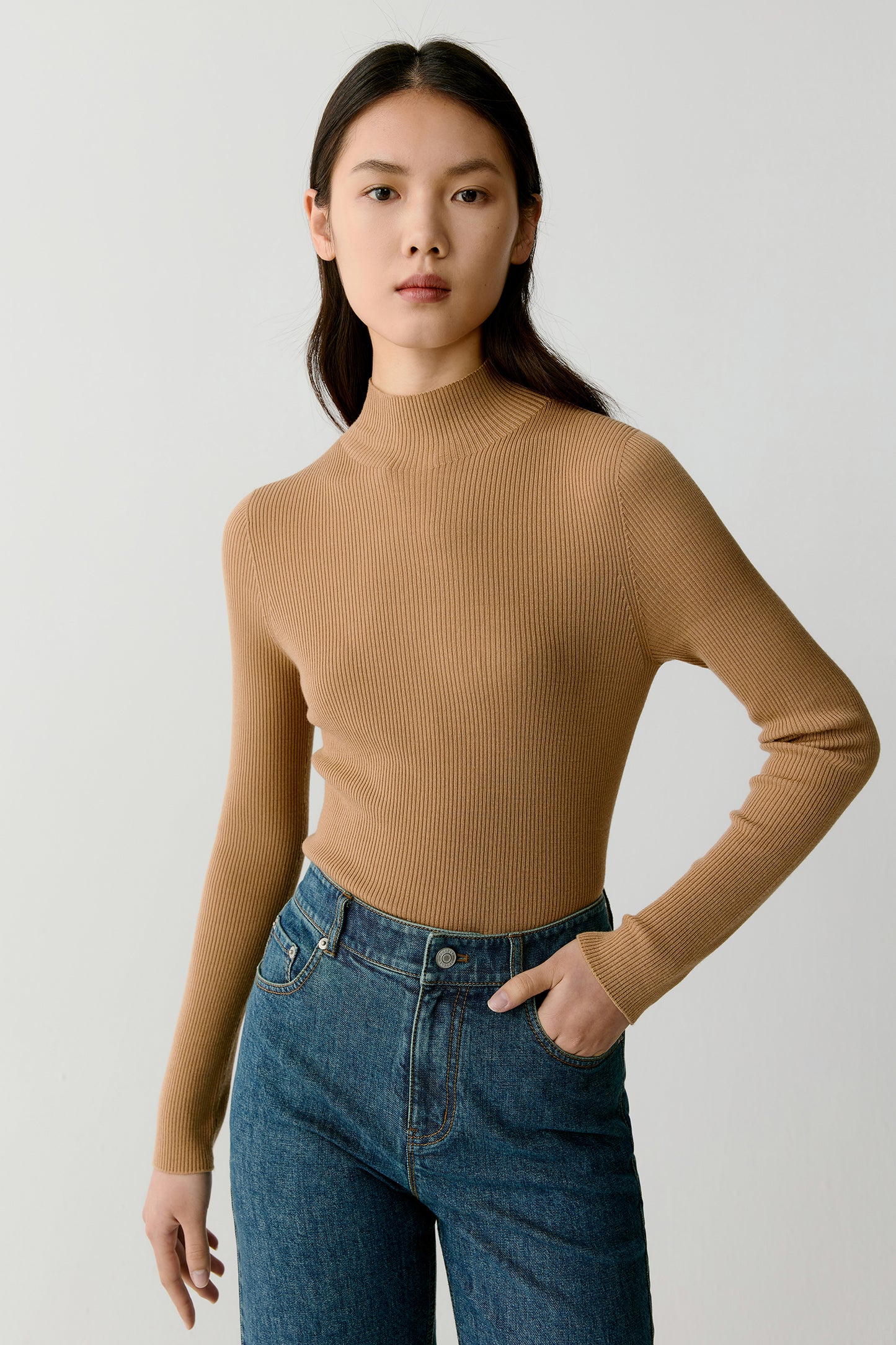 A close-up highlights the ribbed texture and subtle shine of the fine wool.