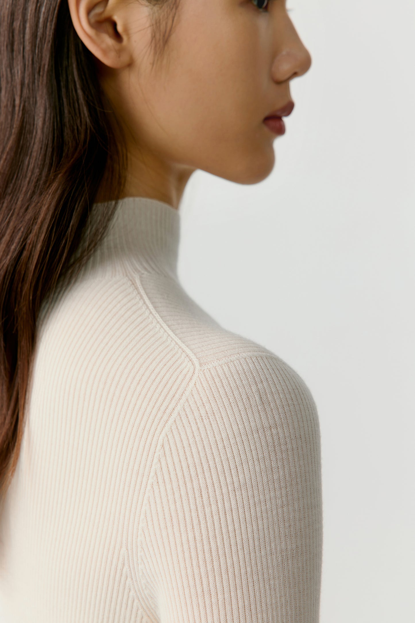 The final frame captures a three-quarter view where the soft lighting accentuates the natural sheen and light warmth of the ivory shade.