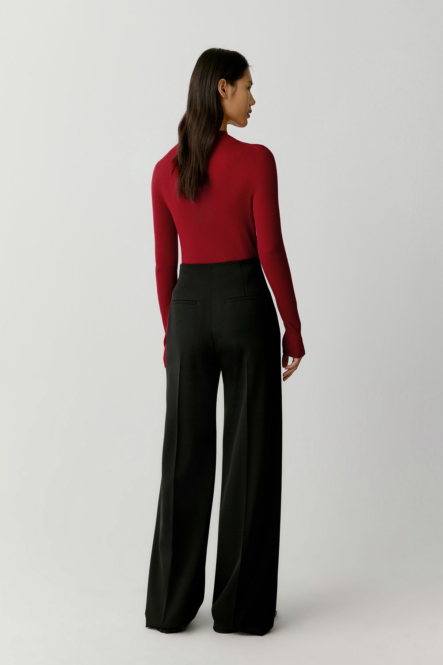 The side view shows the slim, elongated shape and how the mock neck frames the face with softness.