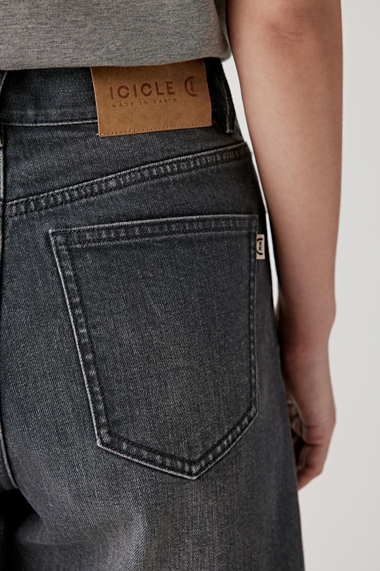 Close-up of waistband and pocket detail, emphasizing texture and stitching.