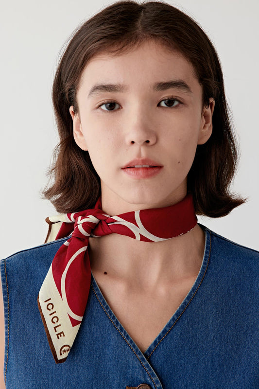 Front view of the red scarf styled at the neck, showing the graphic pattern.