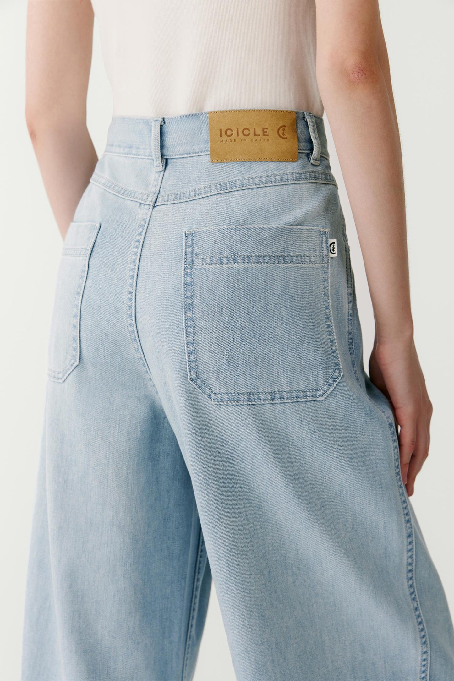Close-up view highlighting the back pocket construction and the soft washed finish of the Earth Denim fabric.