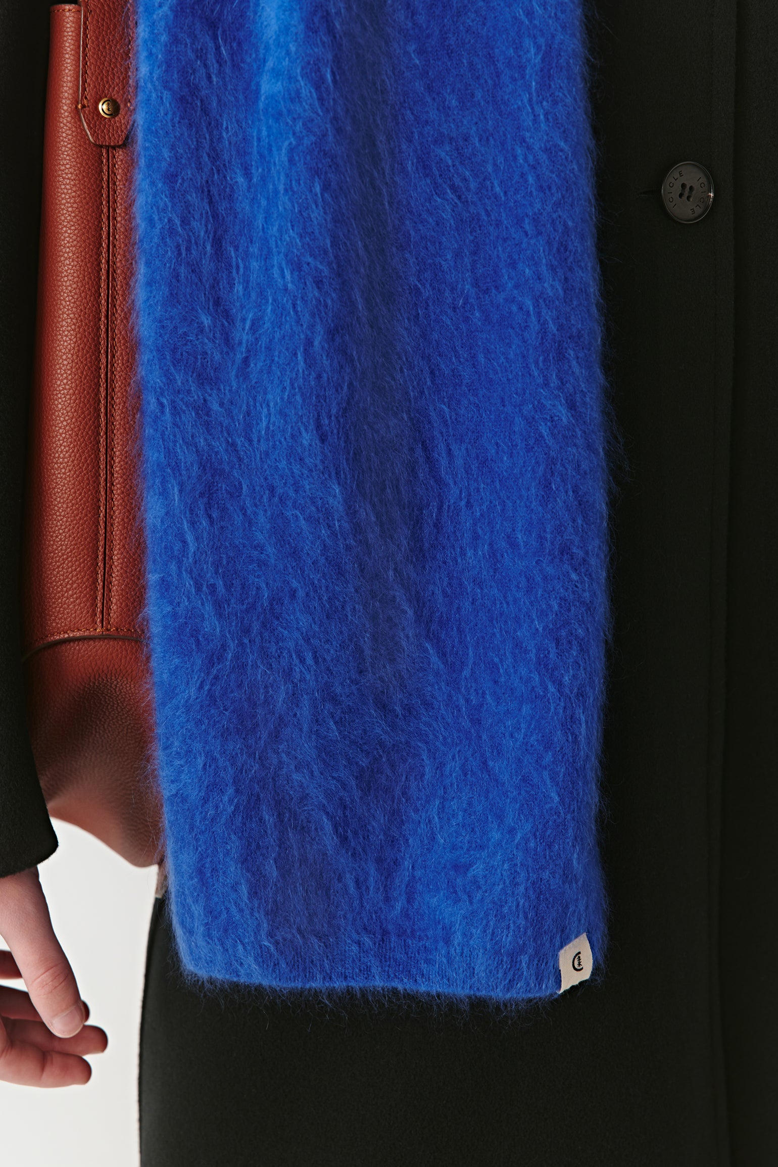Close-up of a vibrant blue wool scarf with soft texture on a light background
