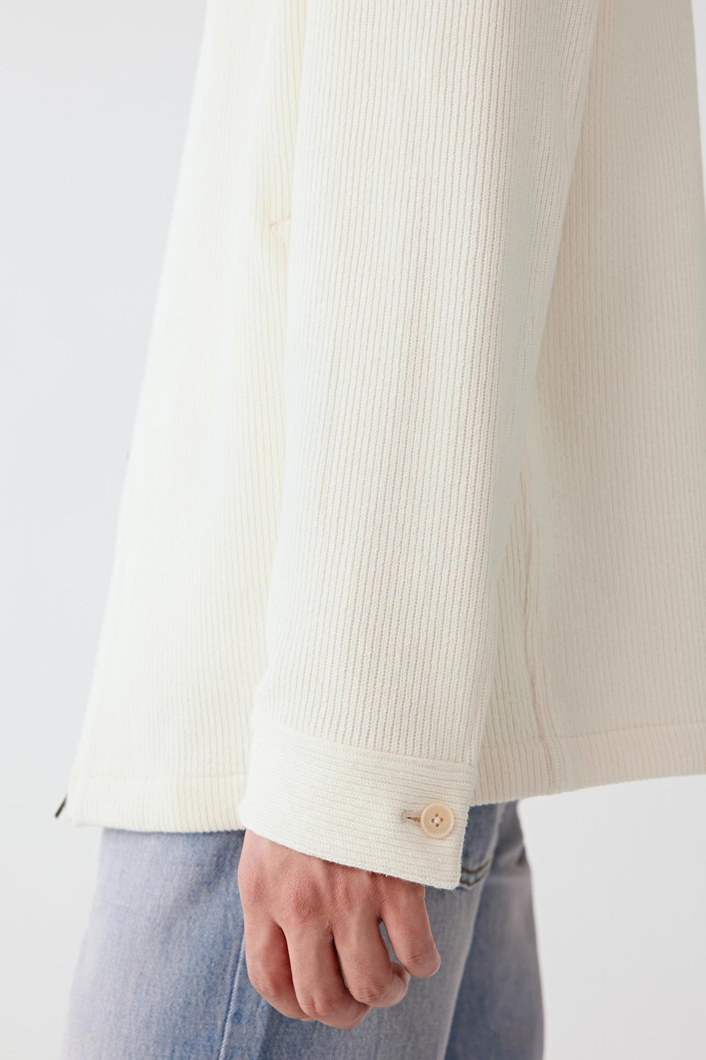 Fabric detail showing the ribbed cotton texture with natural stretch.