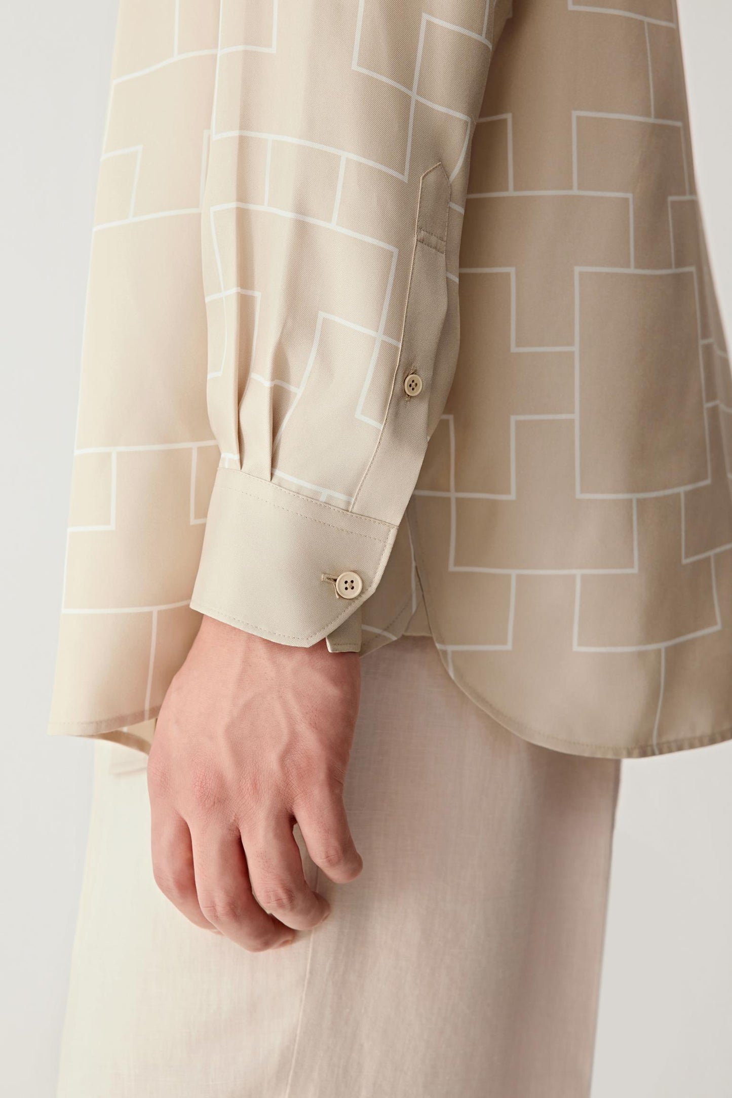 Sleeve detail showing cuff construction and soft sheen of the fabric.