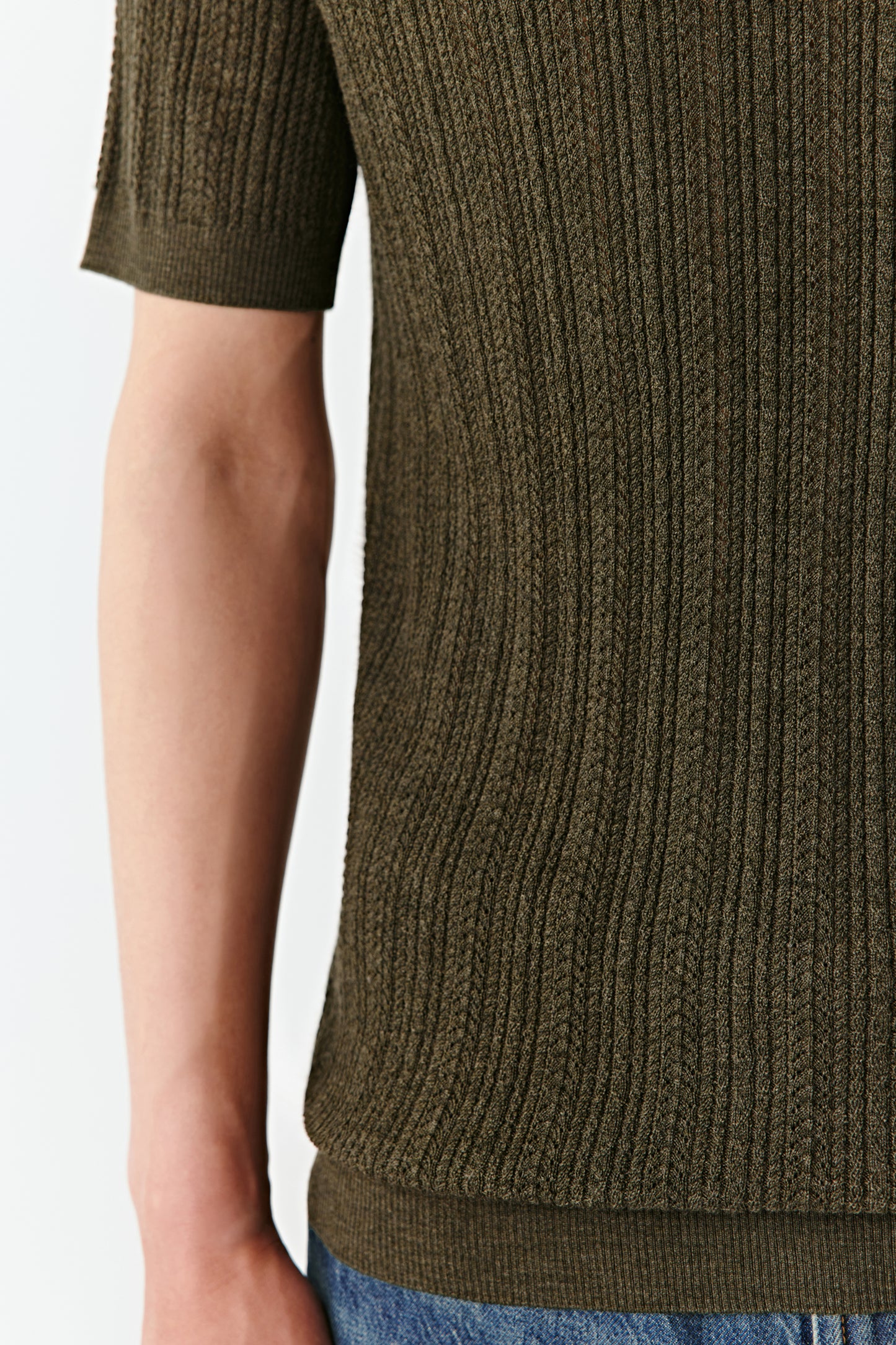 A final macro view reveals the fine rib pattern and subtle sheen of the merino wool fibre.