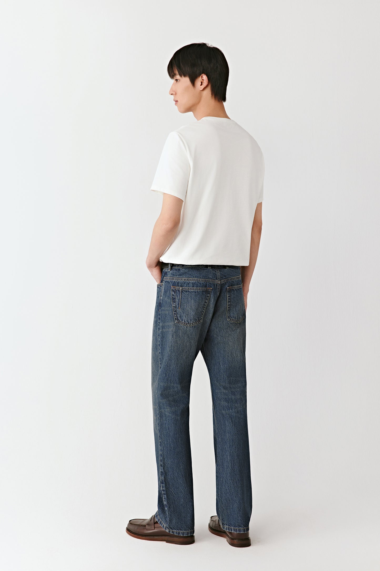 A side view shows the structured cut and even fall of the denim along the leg.