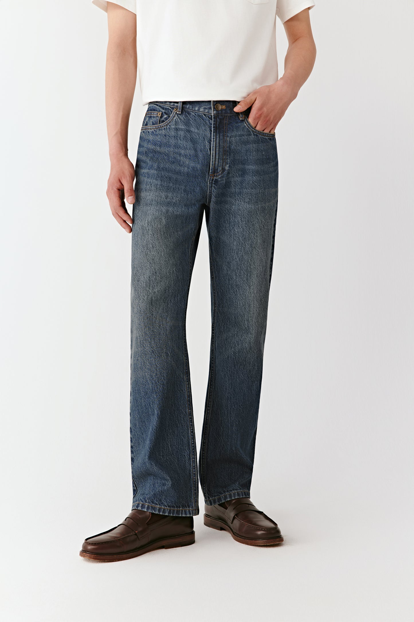 A mid-shot focuses on the waistband and subtle washed texture of the cotton denim.