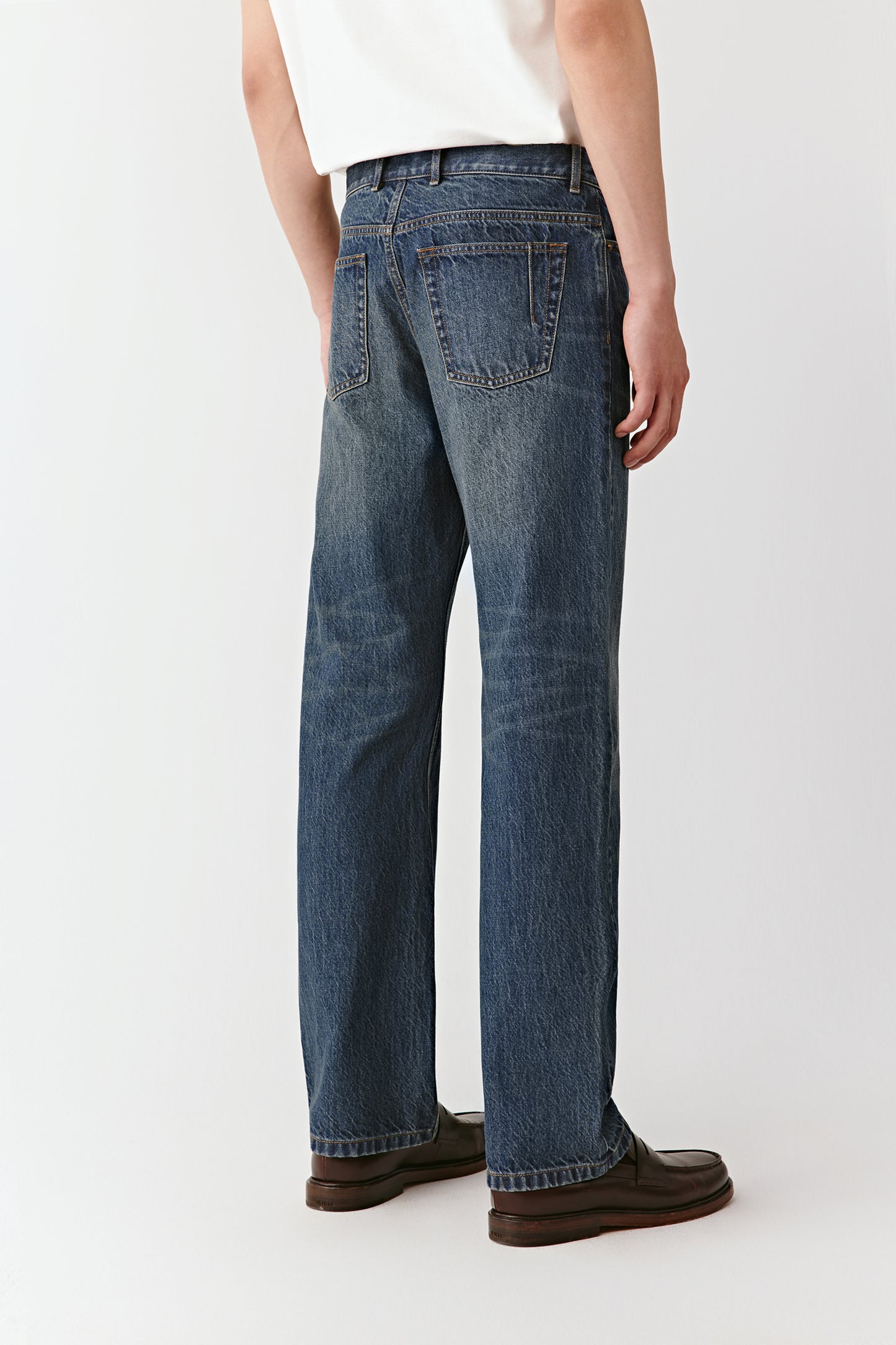 A mid-shot focuses on the waistband and subtle washed texture of the cotton denim.