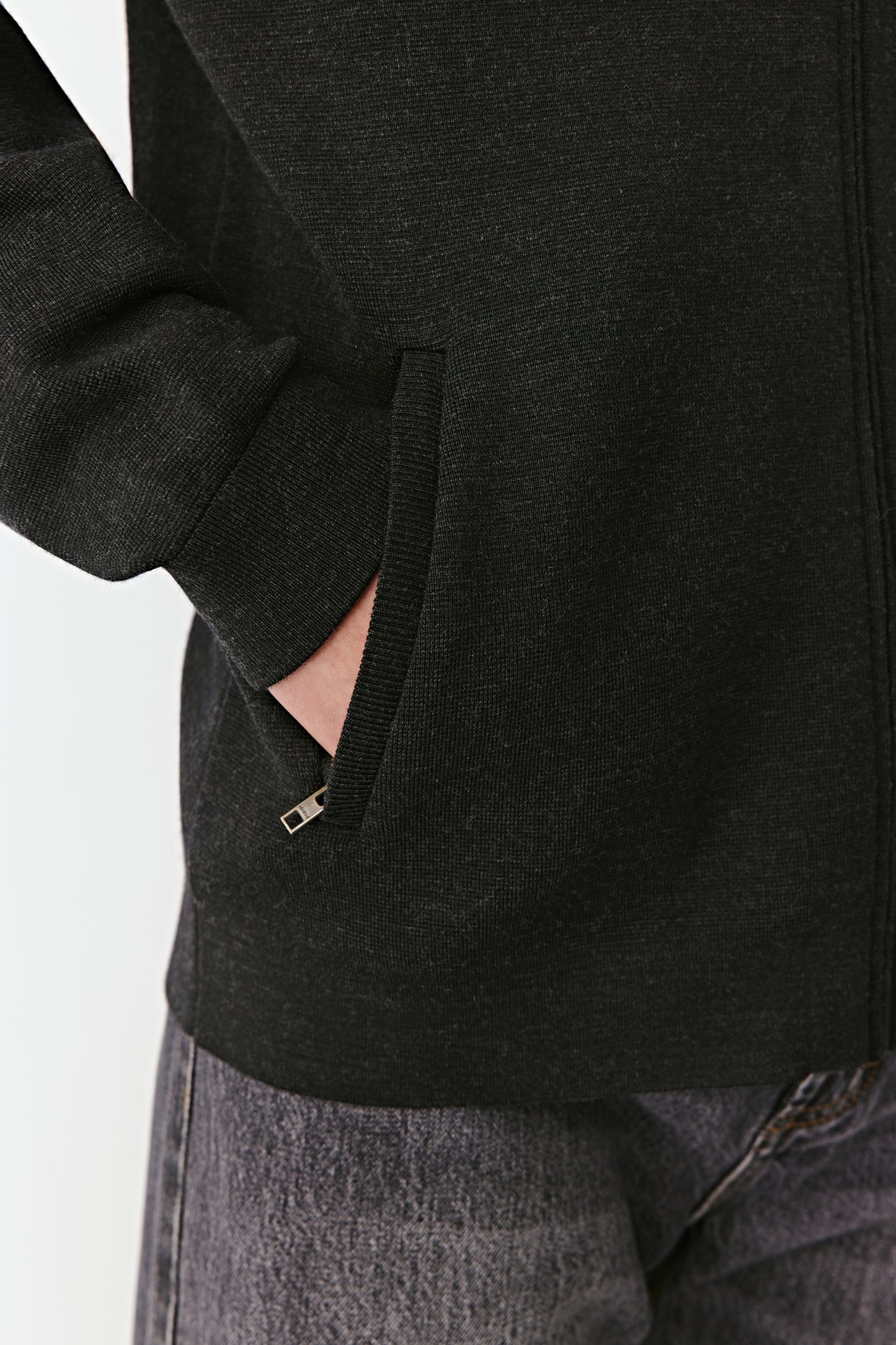 Detail of the sleeve cuff and ribbed hem emphasizing the quality of the finishing.