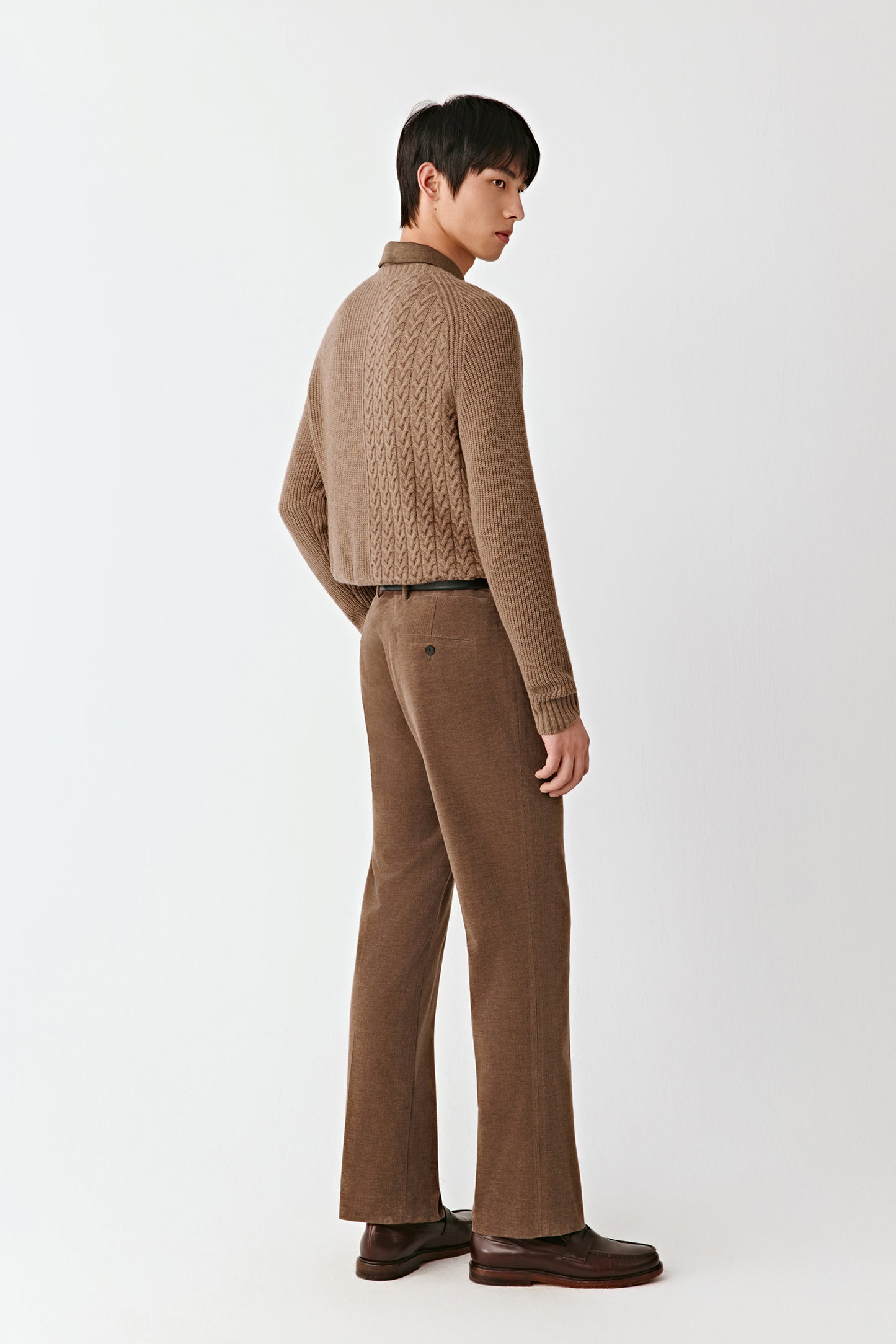 Rear three-quarter view illustrating the pullover’s fitted silhouette and craftsmanship.