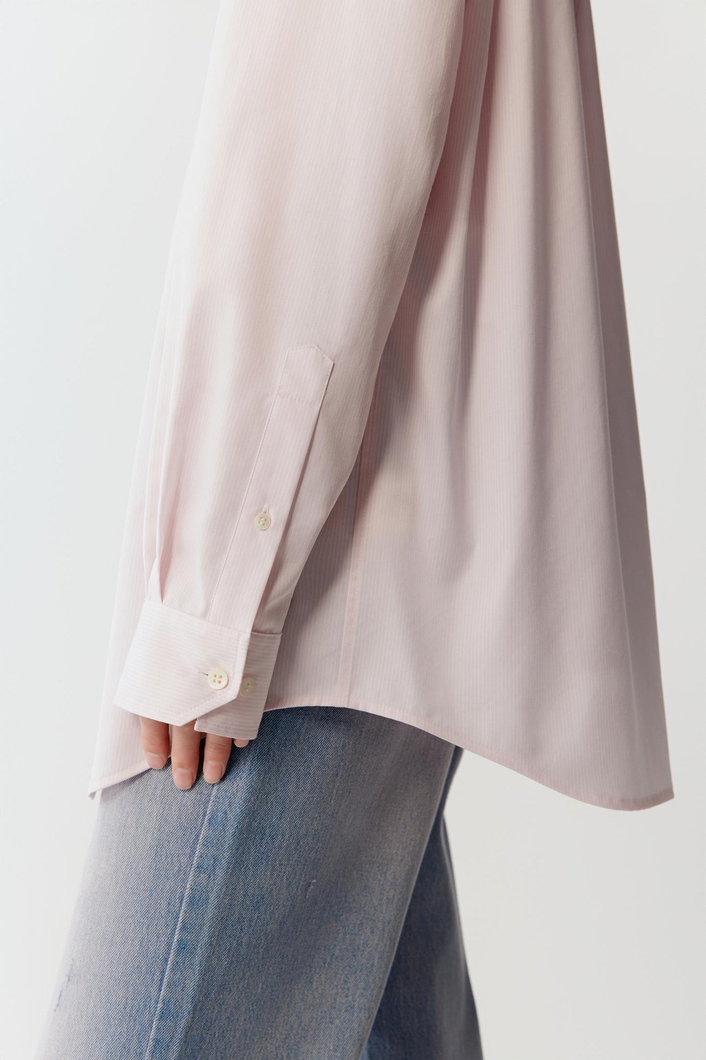 Close-up detail of the sleeve showing the cuff and the vertical stripe pattern.