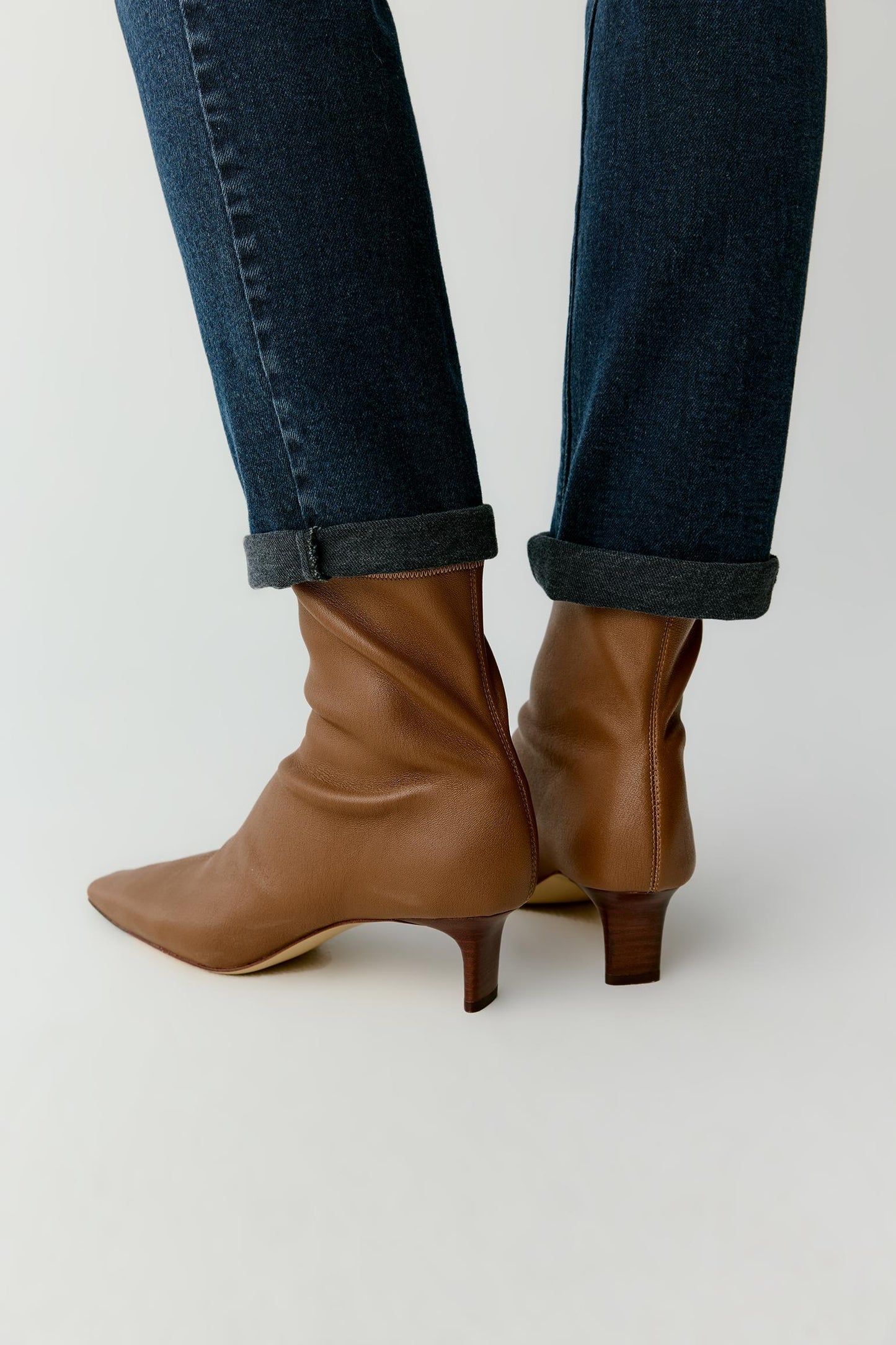 Close-up of the ankle boots from the back, highlighting the clean lines and suppleness of the material.