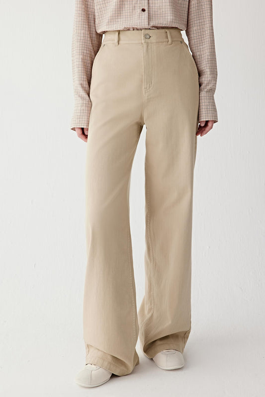 Front view of the wide-leg cotton stretch denim trousers in light sand.