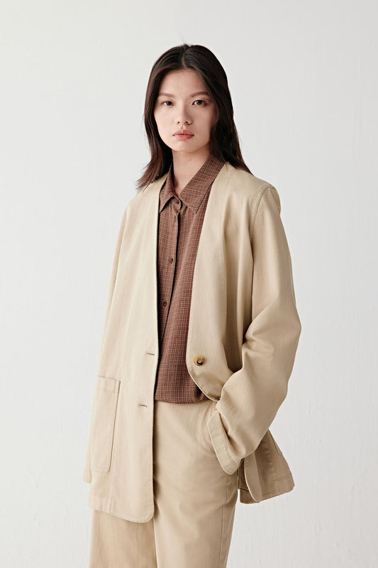 Three-quarter view of the jacket showing the straight cut and patch pockets.
