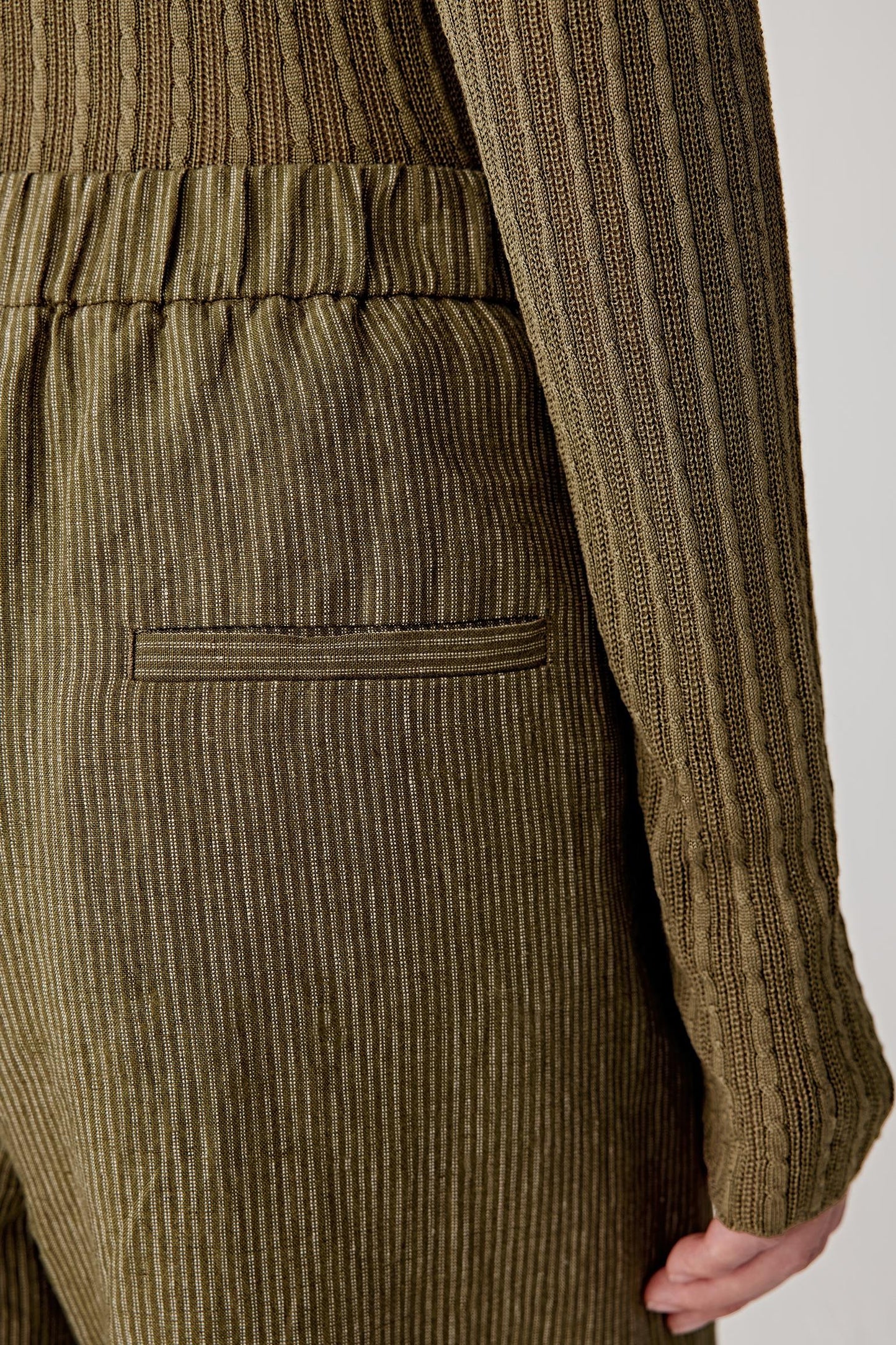 Close-up of fabric showing irregular linen grain, slightly slubbed texture and matte surface