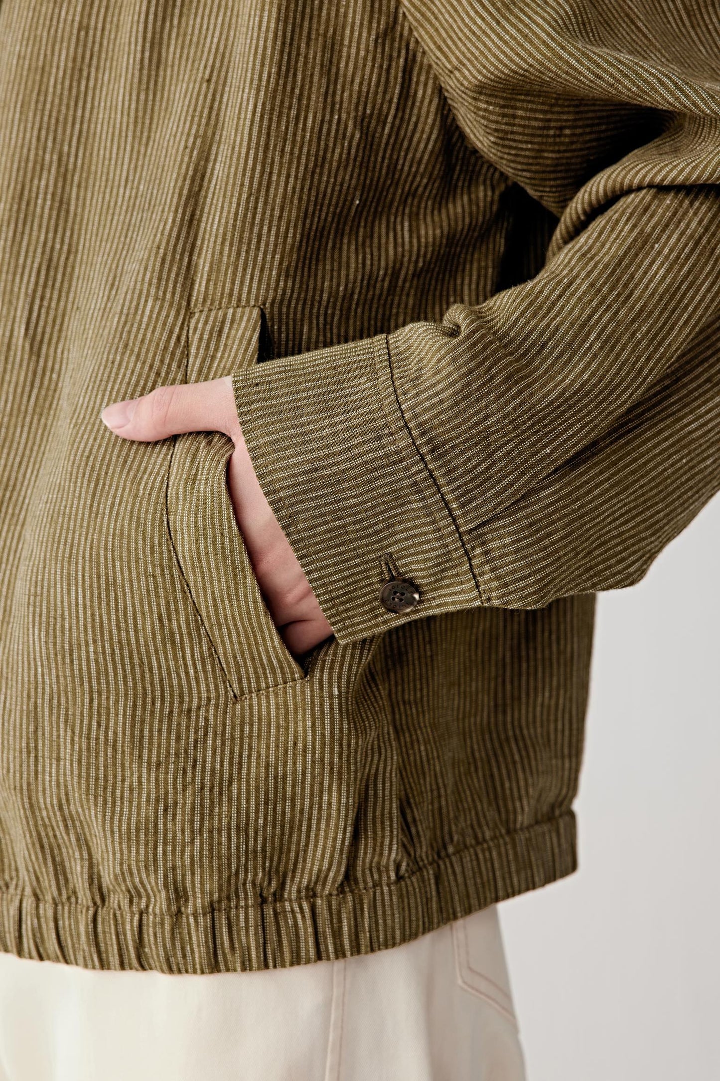 Close-up of sleeve showing stitching, cuff construction and textured surface