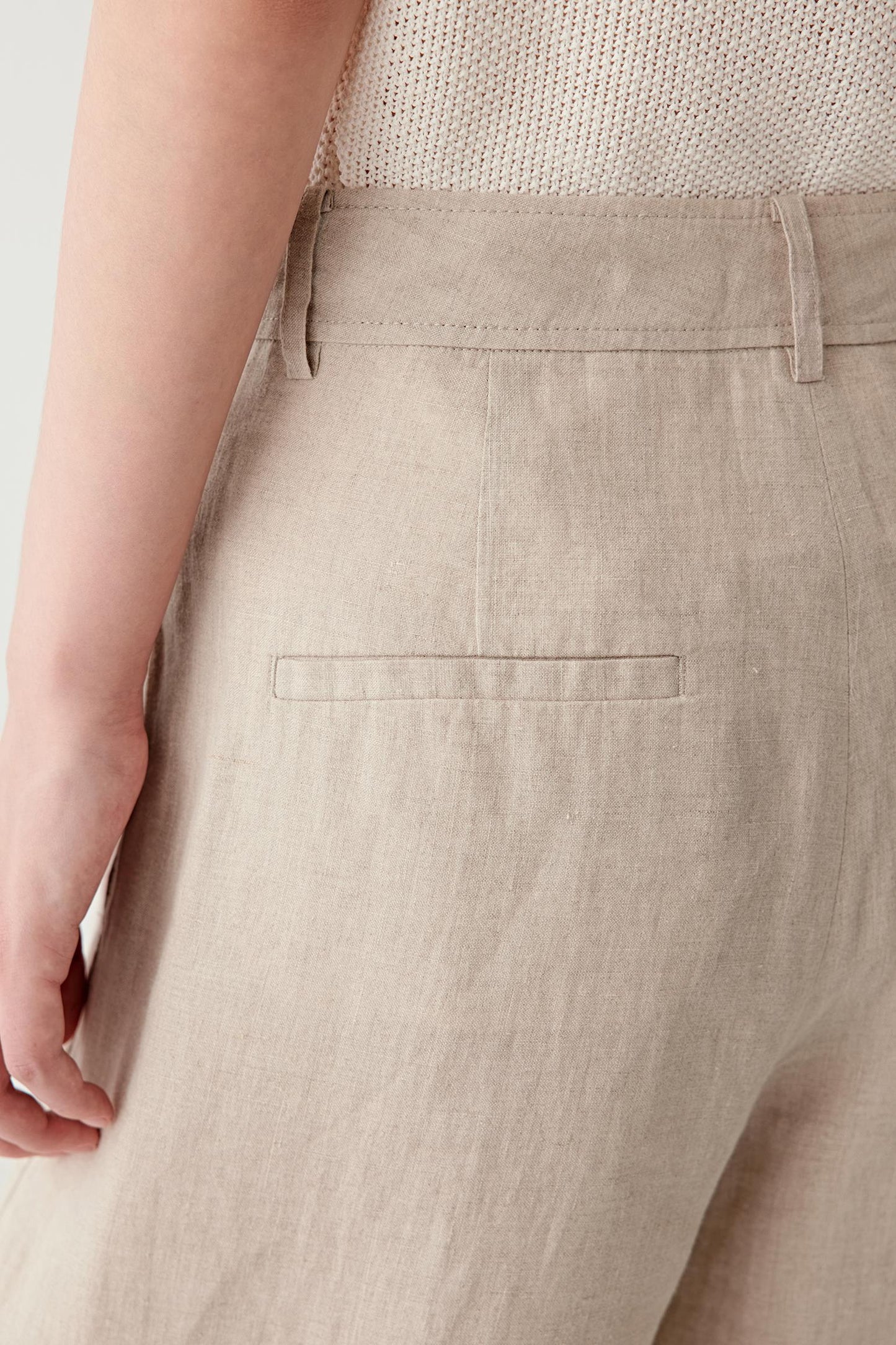 Close-up of side or back pocket showing the lightly textured surface, visible stitching and soft matte finish of the plain-woven linen fabric