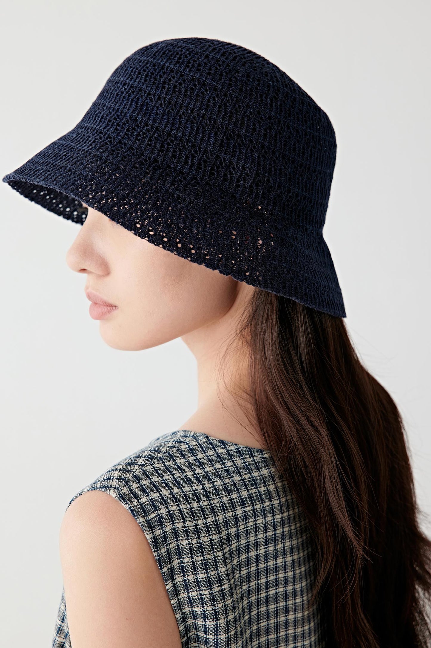 Rear three-quarter view showing the back of the hat, highlighting the rounded crown, continuous knit construction and the clean line of the brim encircling the head