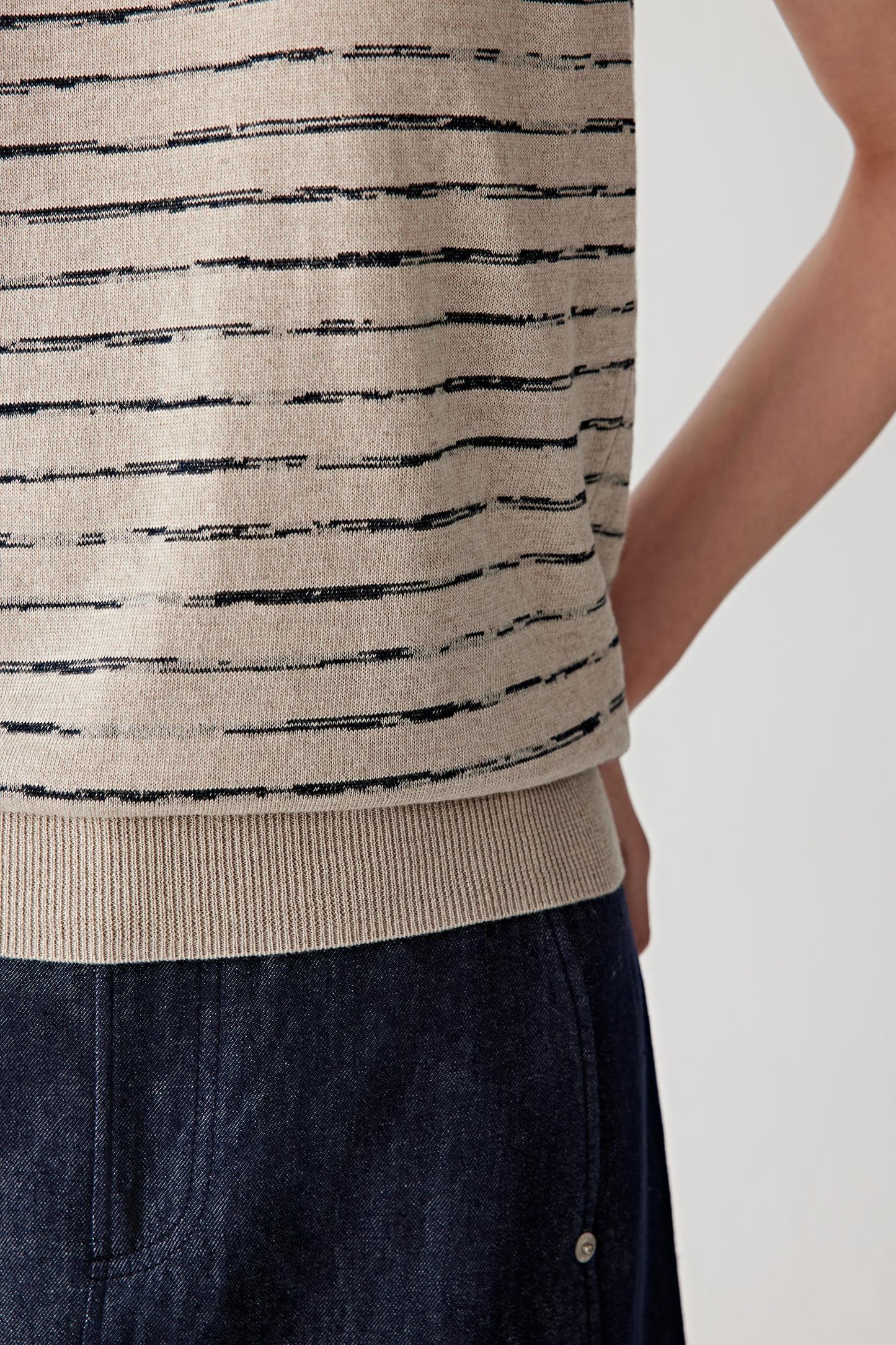 Close-up of hem and side showing knit density and finishing
