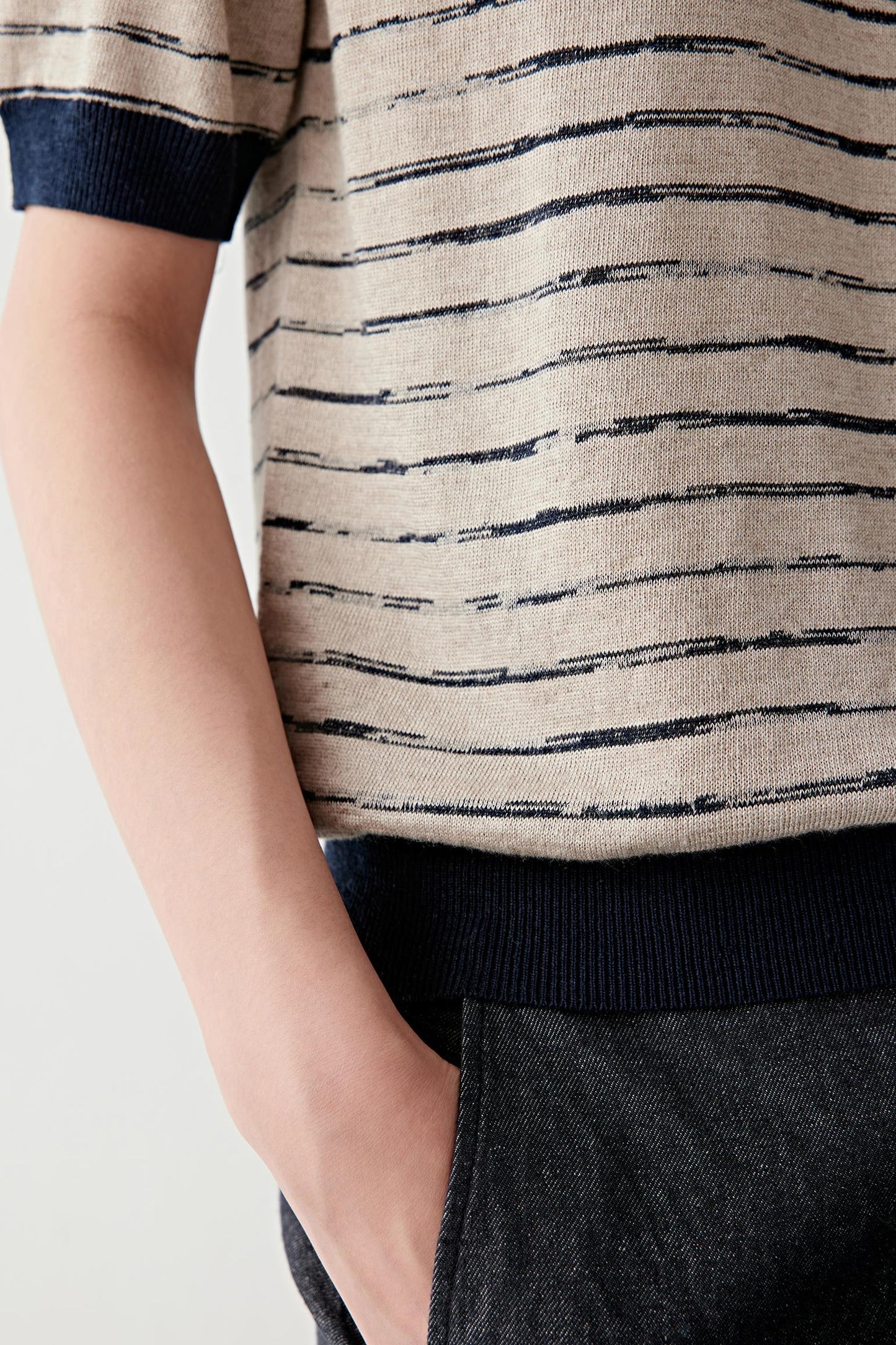 Close-up of sleeve and side showing fine knit construction and slightly textured surface