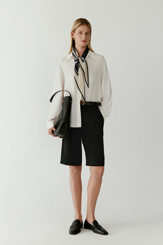 Full-length view of the silk twill scarf styled with a white blouse and black skirt.