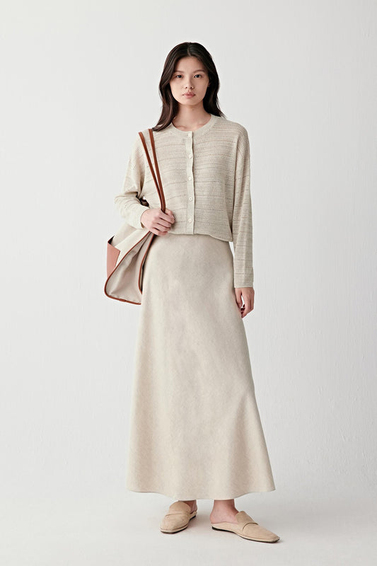 Full-length front view showing the cardigan layered over a matching dress, emphasizing the fluid fit, front button fastening and lightweight breathable knit structure