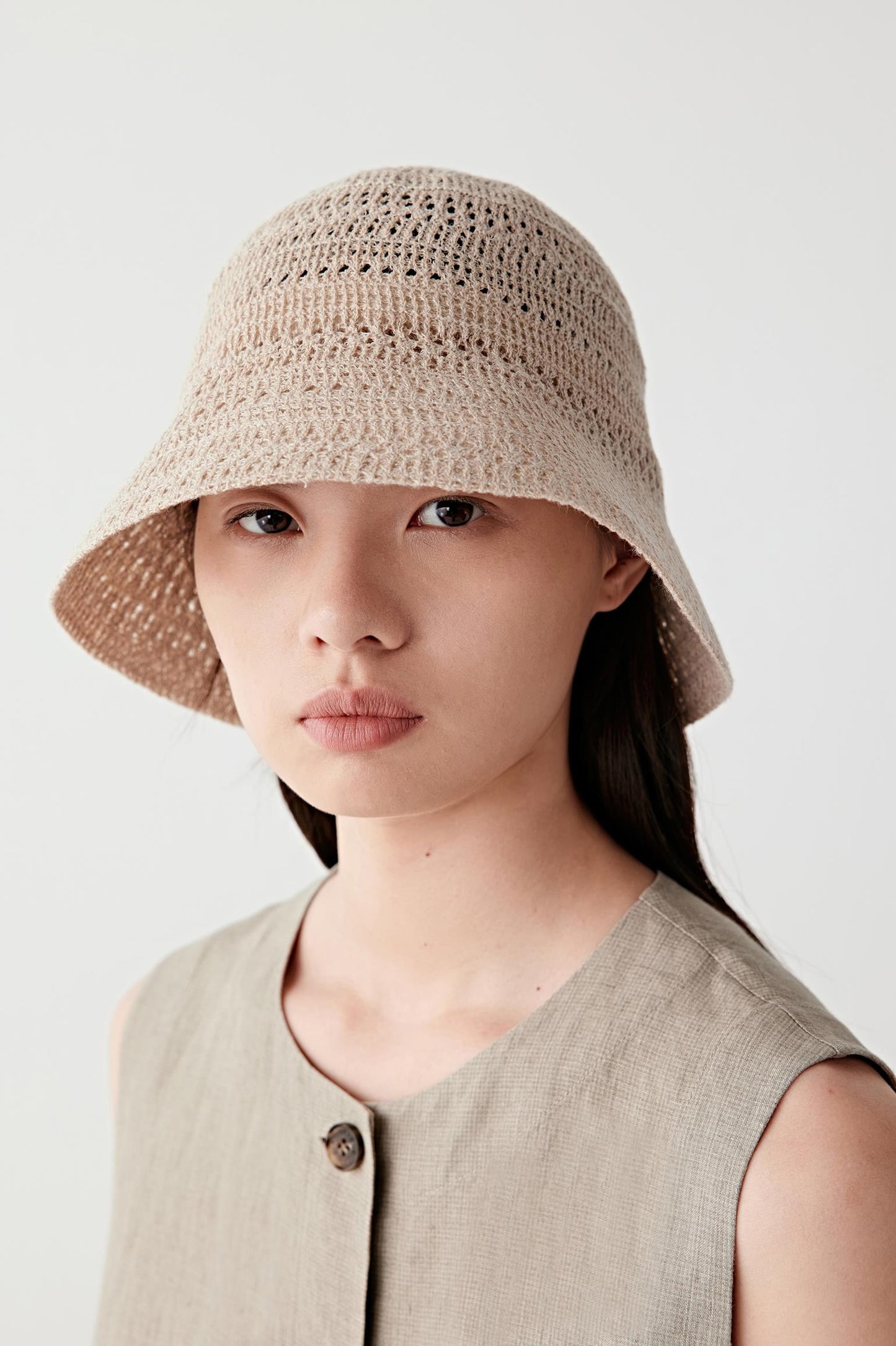 Rear three-quarter view showing the back of the hat, with a continuous knit construction, rounded crown and clean, uninterrupted brim line encircling the head