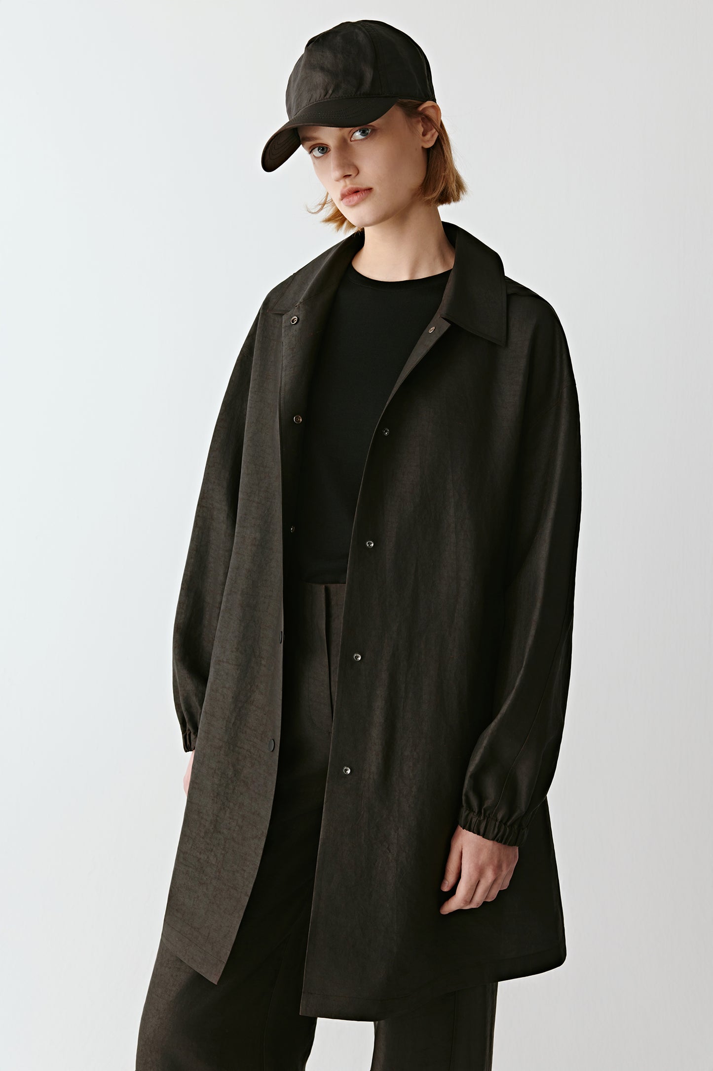 Portrait capturing the collar, zip, and gathered sleeve details.