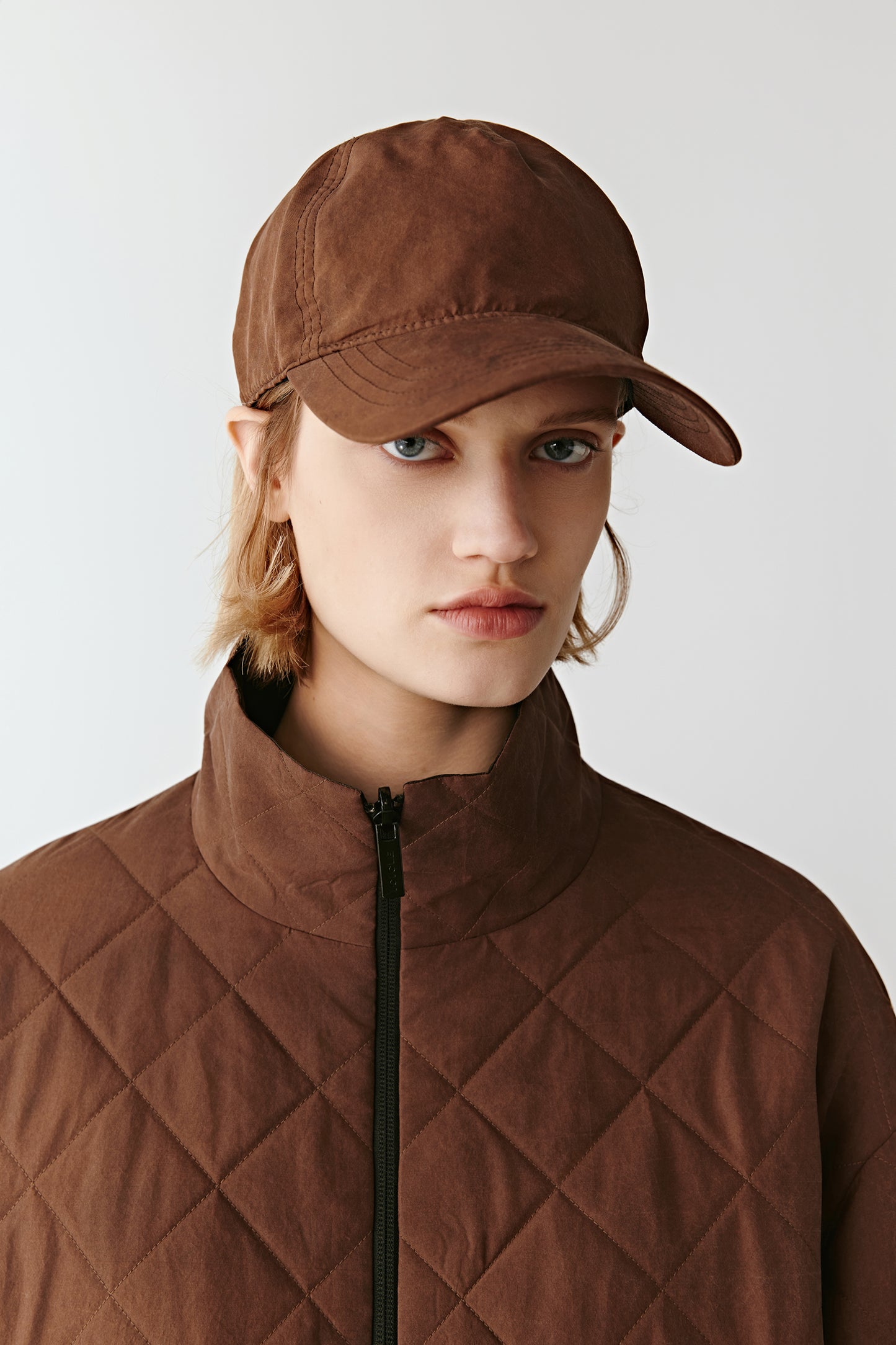 Portrait focusing on the round neckline and diamond quilt pattern.