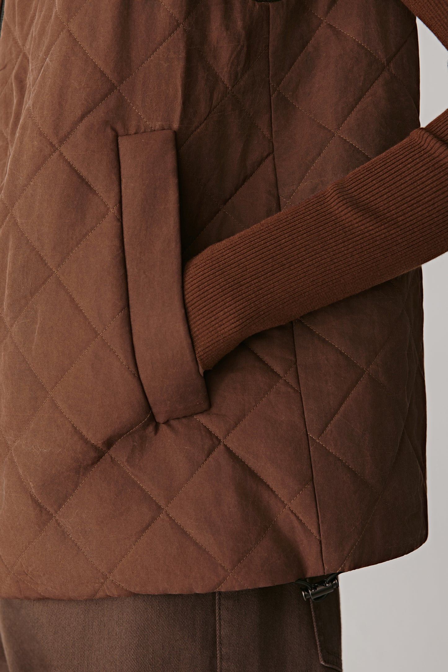 Close-up highlighting the pocket detail and vertical quilt stitching.