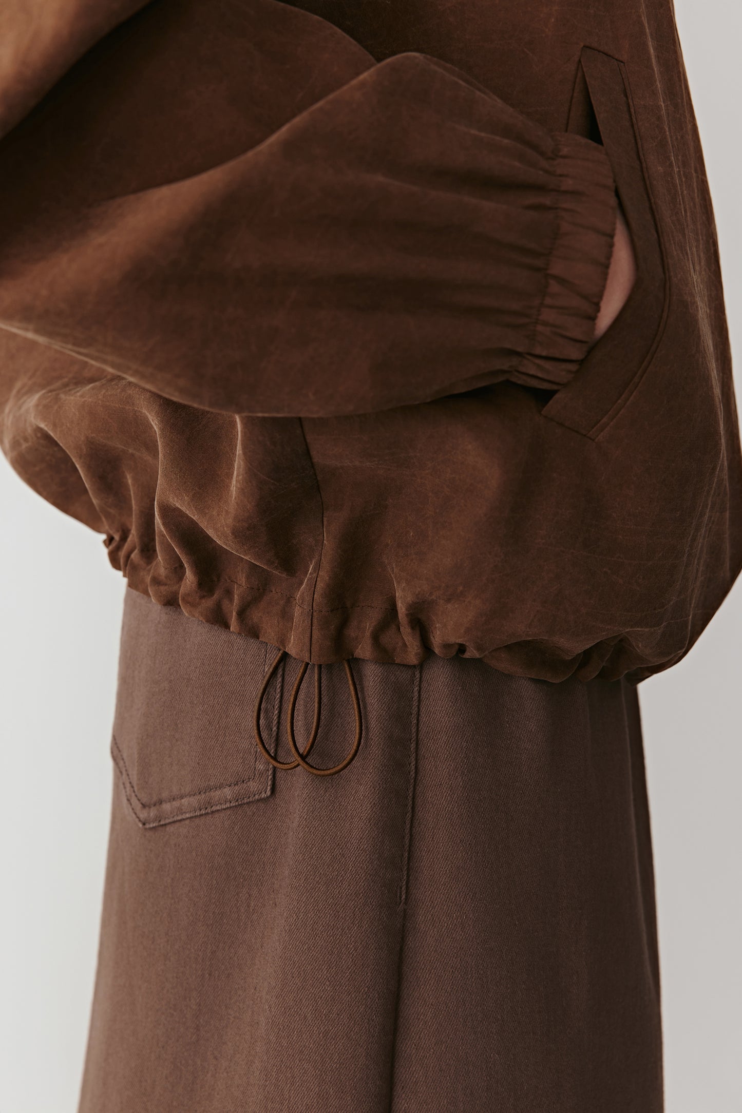 Detail of the sleeve cuff and gathered hem revealing the craftsmanship of the silk gauze.