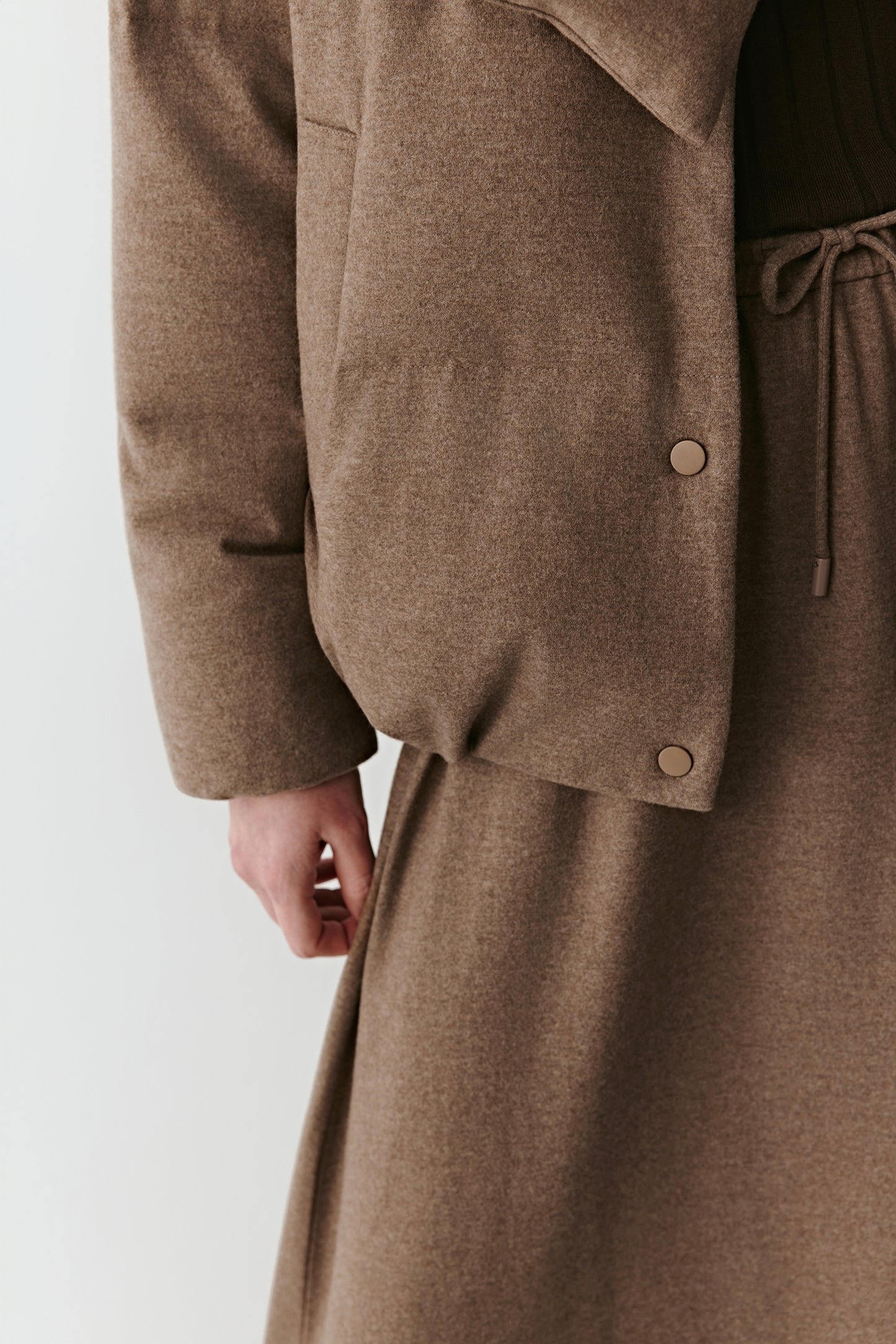 Close-up on sleeve and pocket area showing refined seams.