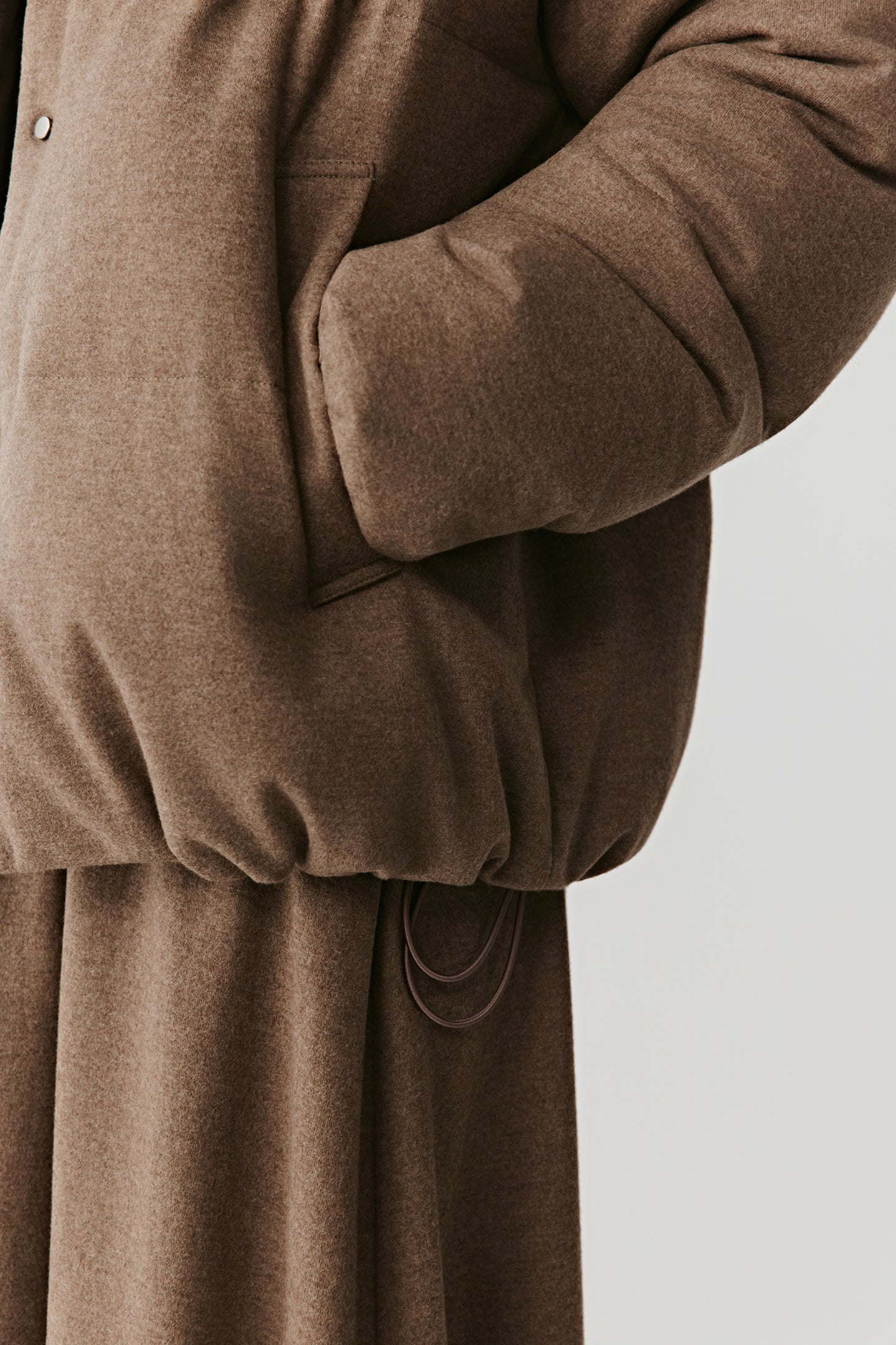 Close-up on sleeve and pocket area showing refined seams.