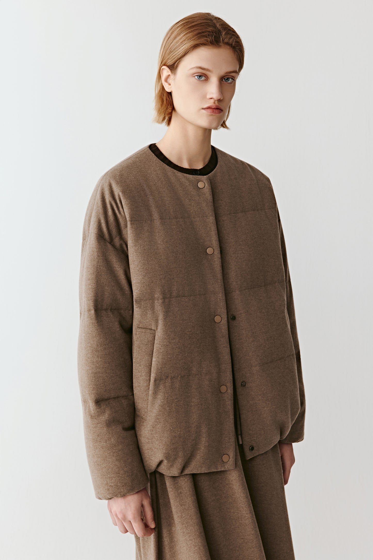 Texture detail revealing the fine melange surface of the wool-yak fabric.