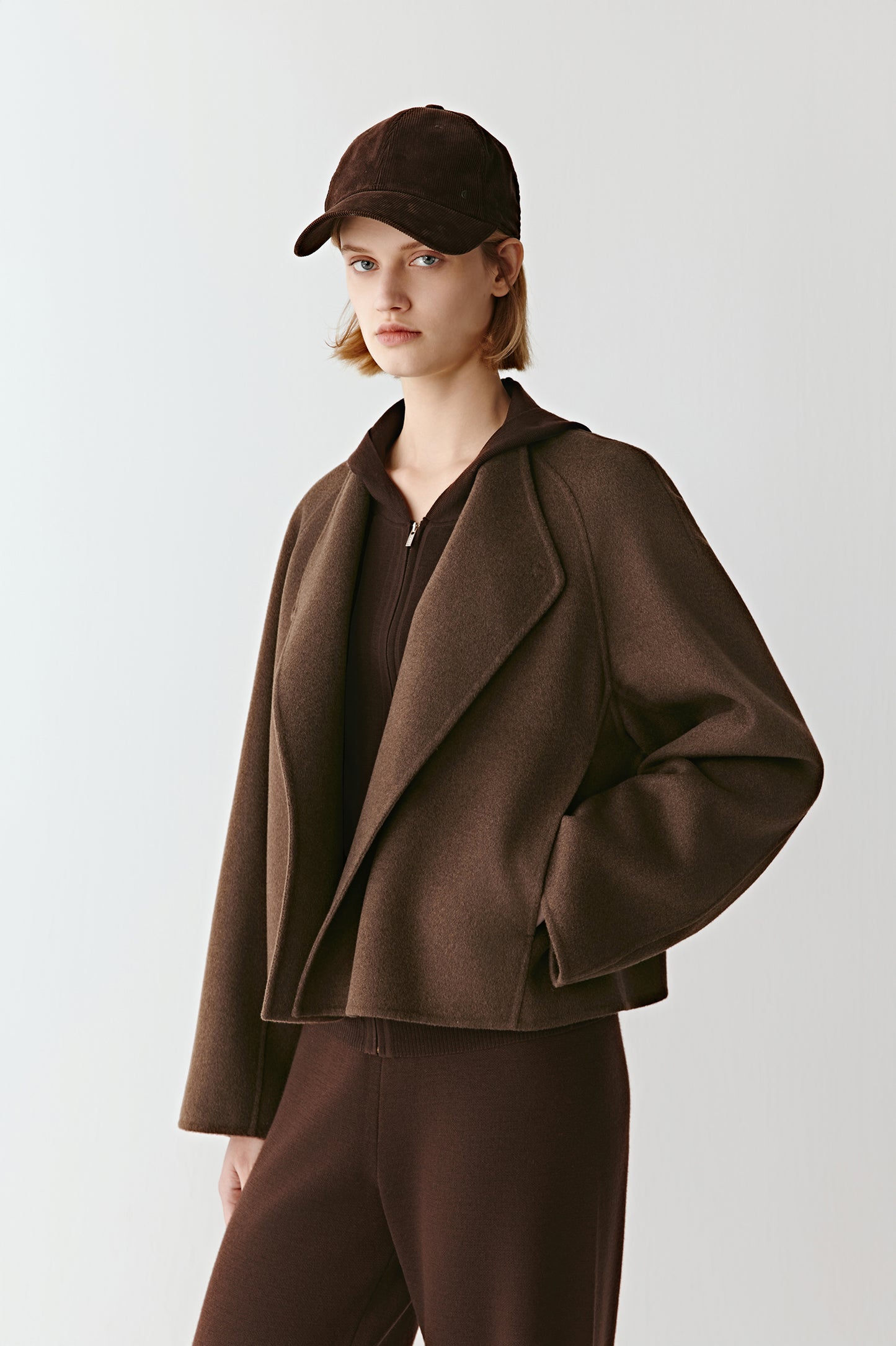 Side view emphasizing its wide sleeves and fluid volume.