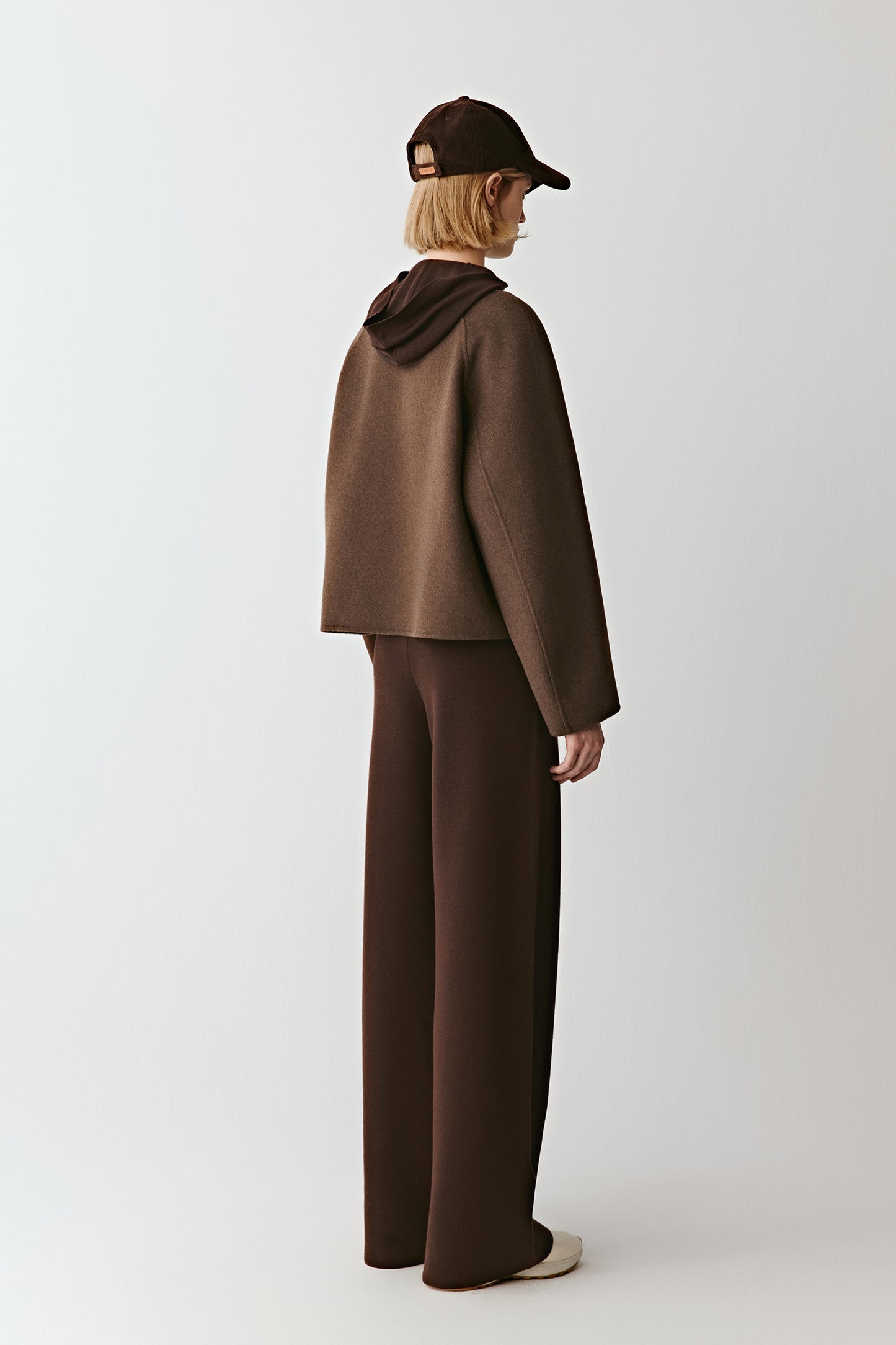 Side view emphasizing its wide sleeves and fluid volume.