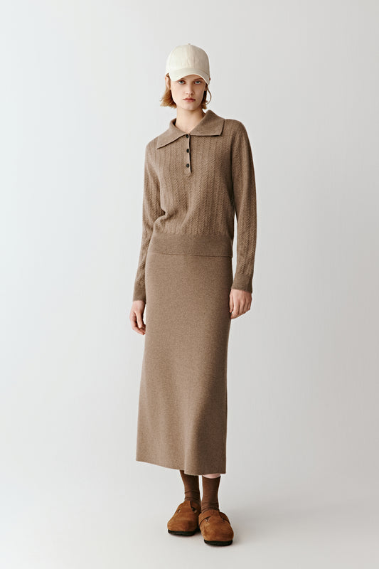 Model wearing a camel undyed cashmere and wool midi skirt with a matching knit top for a tonal silhouette.