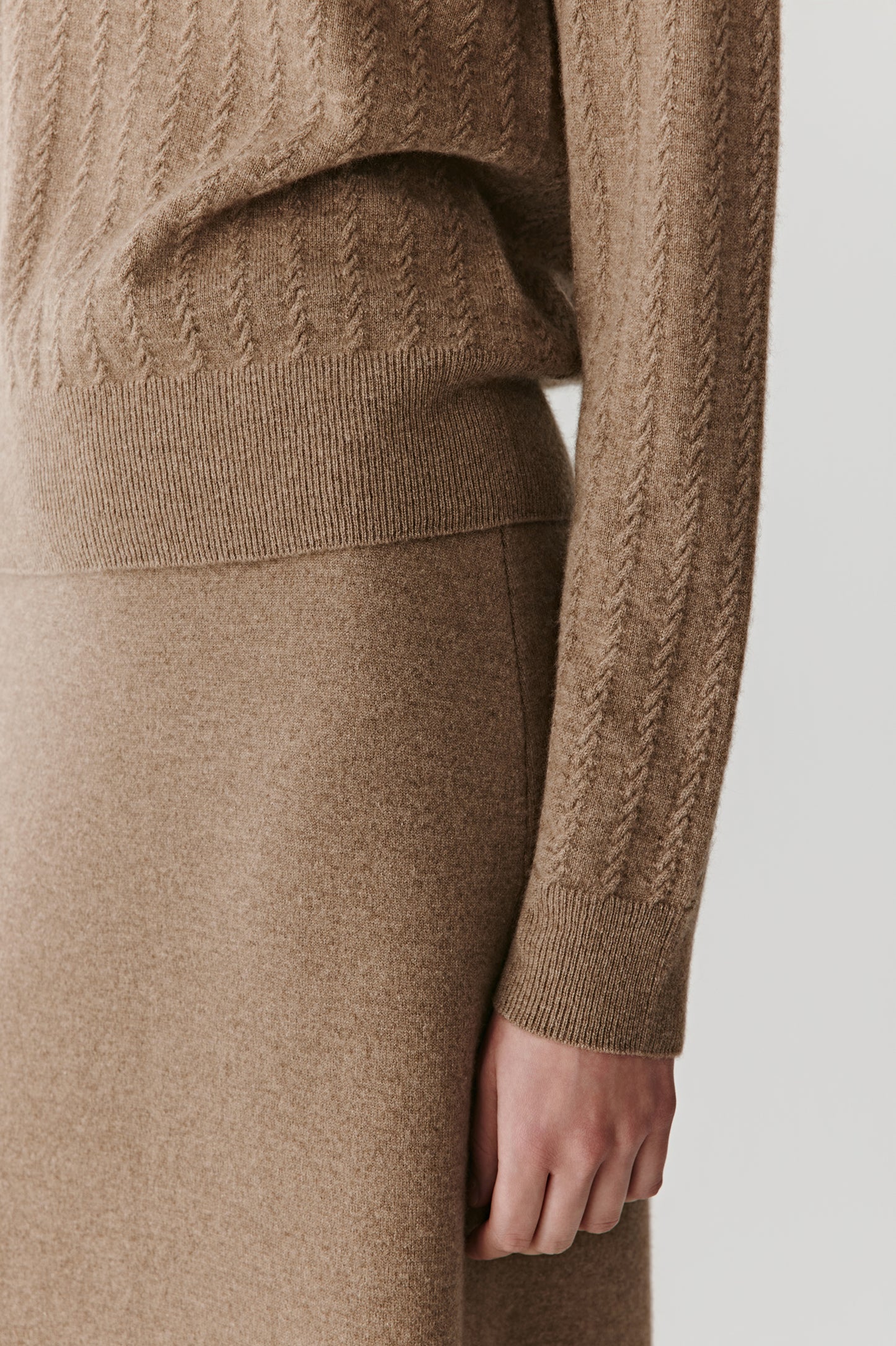 Fabric detail focusing on the natural undyed fibre with its soft handfeel and subtle tonal variations in the camel shade.