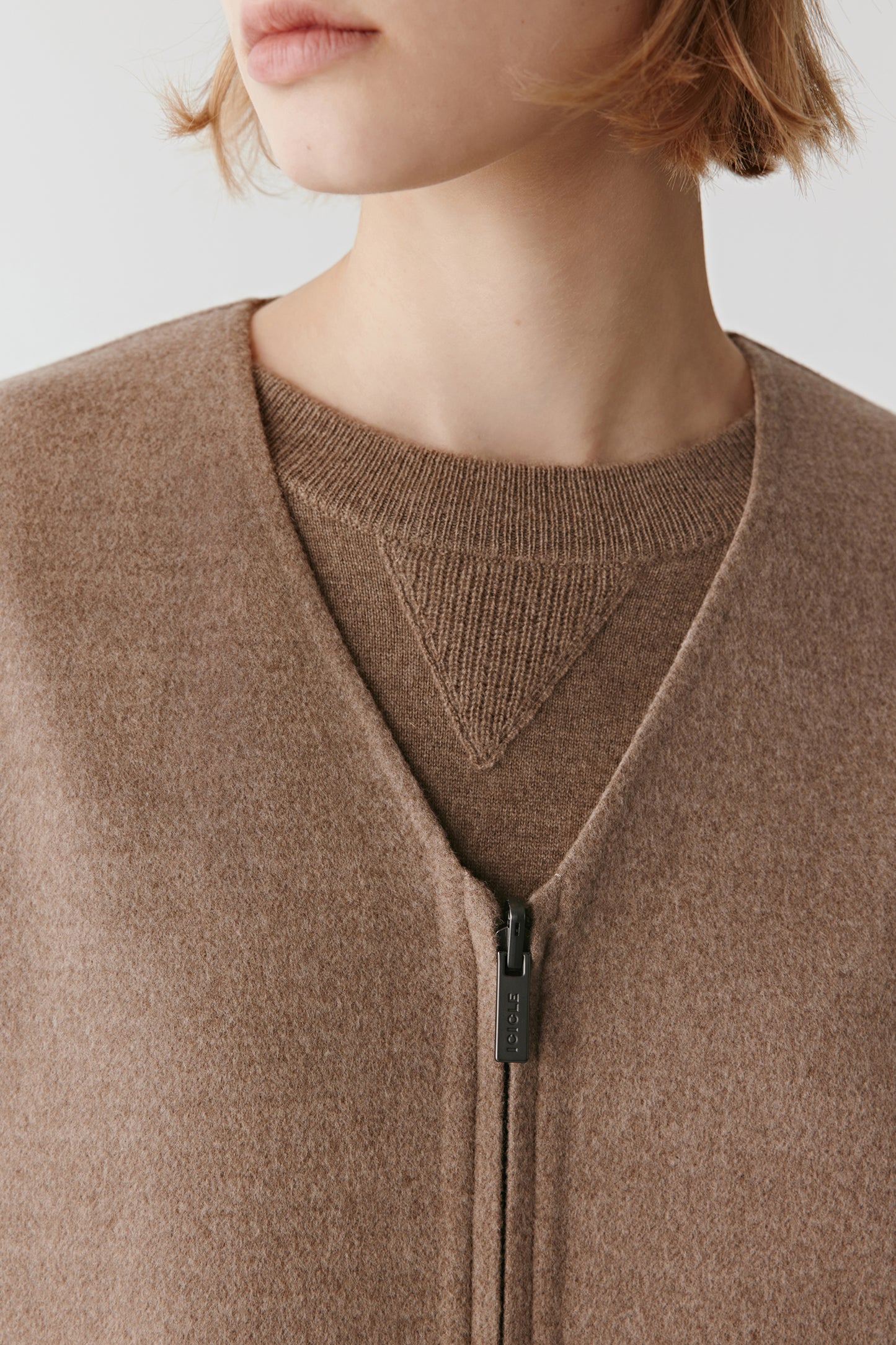 Detailed view of the collar and shoulder line showing precise tailoring and the natural sheen of the silk blend.