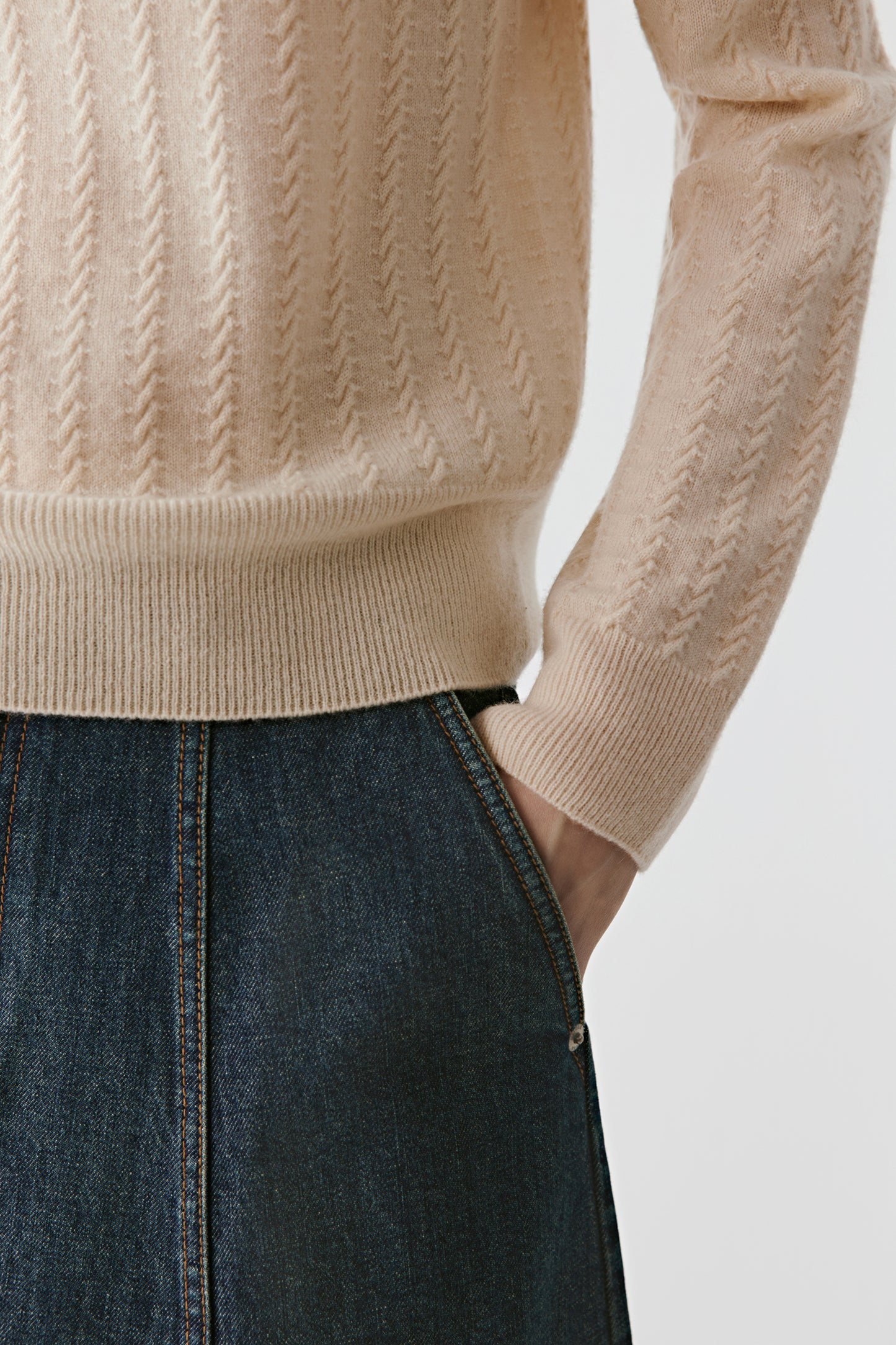 Close-up of the ribbed edge and neat finishing around the cuffs and hem.